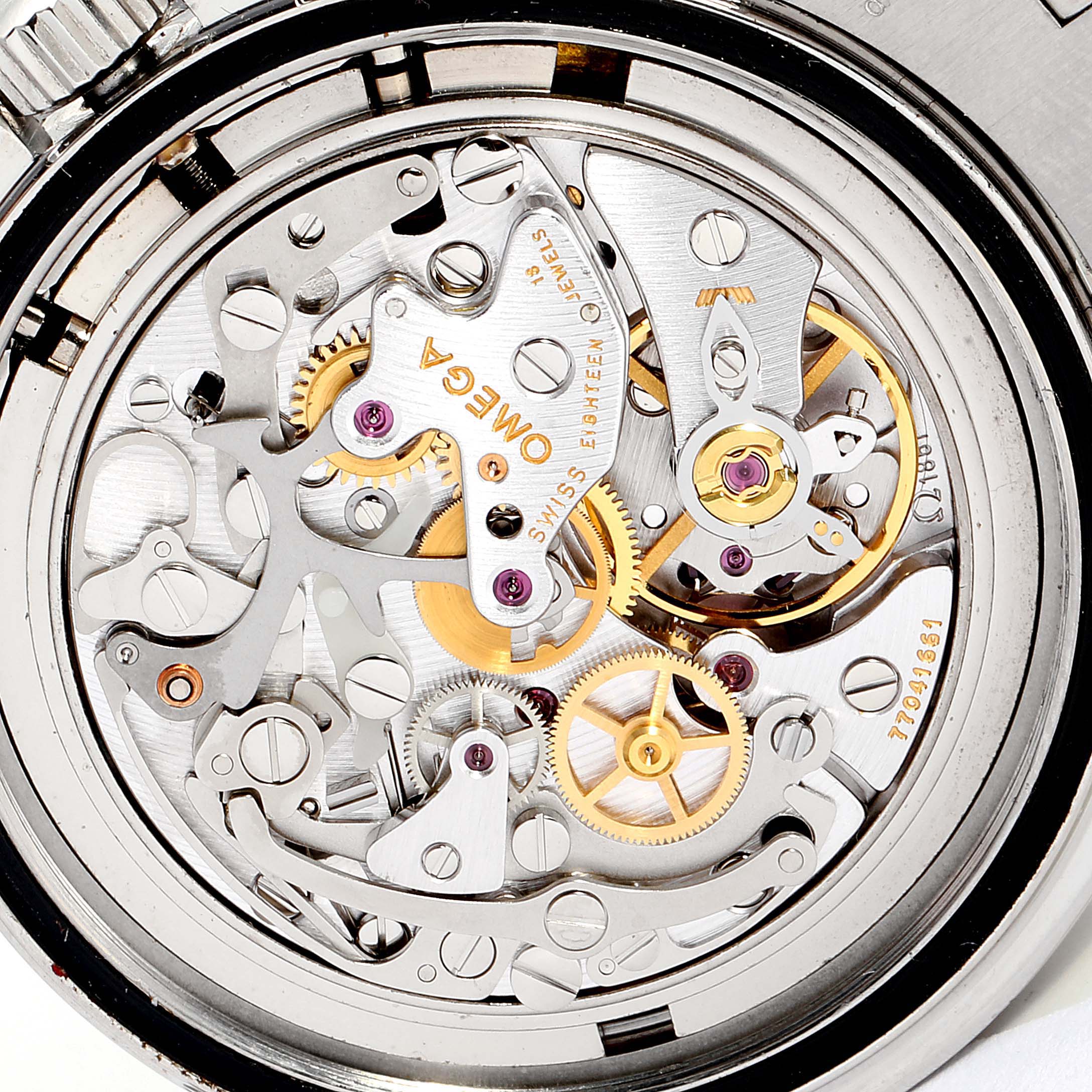 The image shows the internal mechanism of an Omega Speedmaster 3570.50.00  Men
s Stainless Steel Black Dial 3570.50.00  Men
s Stainless Steel Black Dial watch from a rear angle, highlighting its intricate gears and components.