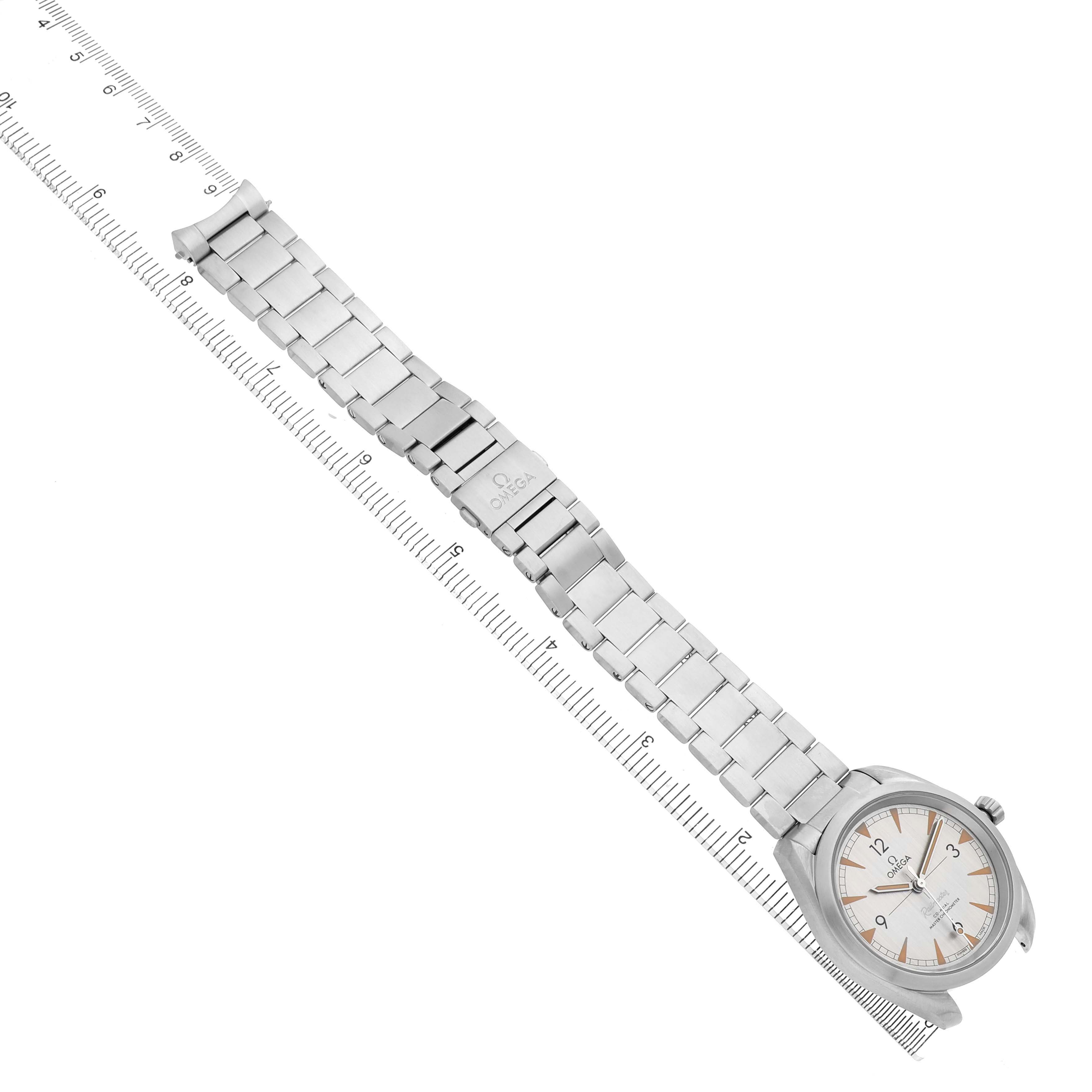 The image shows an Omega Aqua Terra 220.10.40.20.06.001 Men's Stainless Steel Grey Dial watch laid flat with a focus on the bracelet and case, accompanied by a measuring scale.