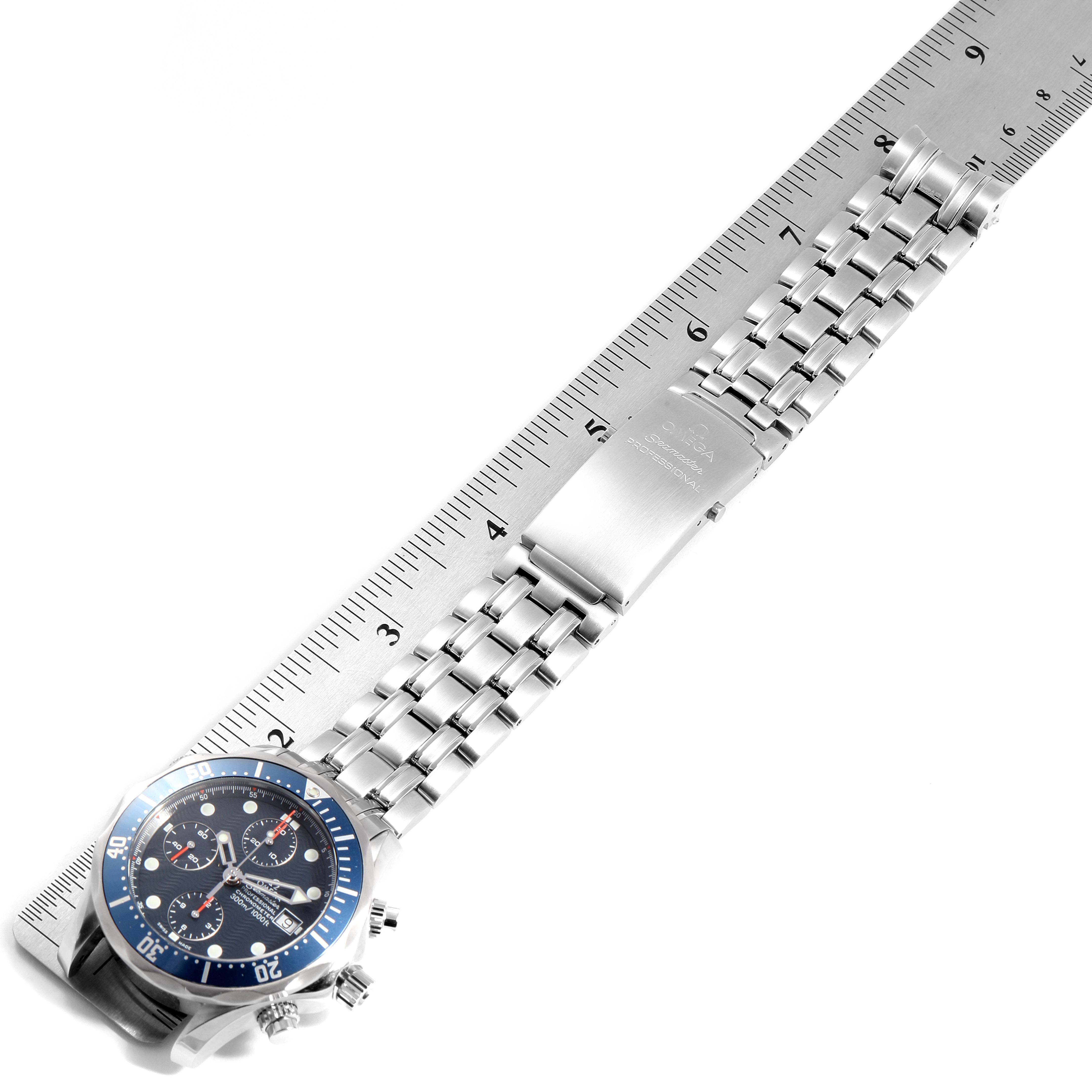 The image shows an Omega Seamaster 2599.80.00 Men
s Stainless Steel Blue Dial 2599.80.00 Men
s Stainless Steel Blue Dial watch lying flat with its dial and bracelet visible alongside a ruler for scale.