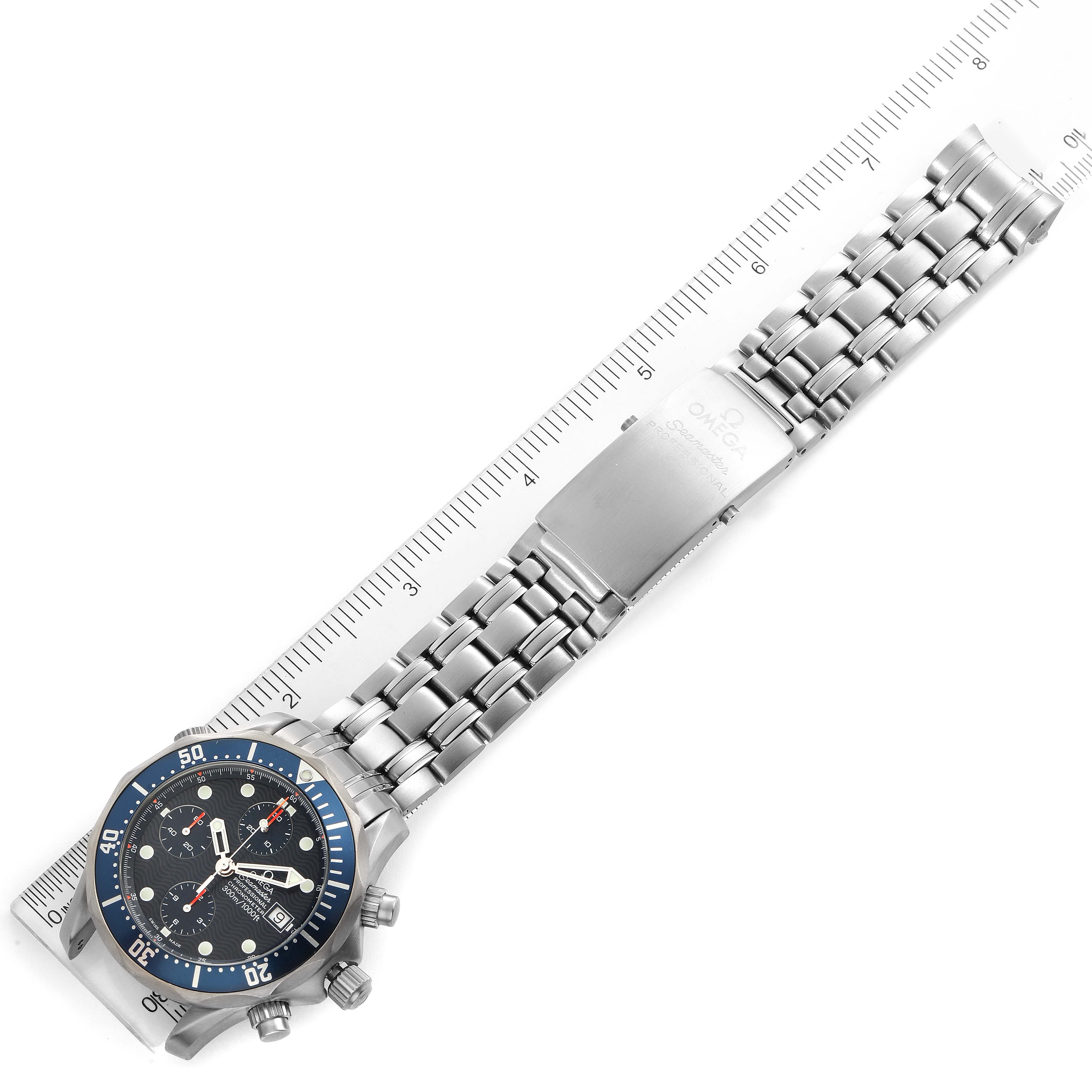 The Omega Seamaster 2298.80.00 Men
s Titanium Blue Dial 2298.80.00 Men
s Titanium Blue Dial watch is shown from an overhead angle, displaying the full band and face alongside a ruler for scale.