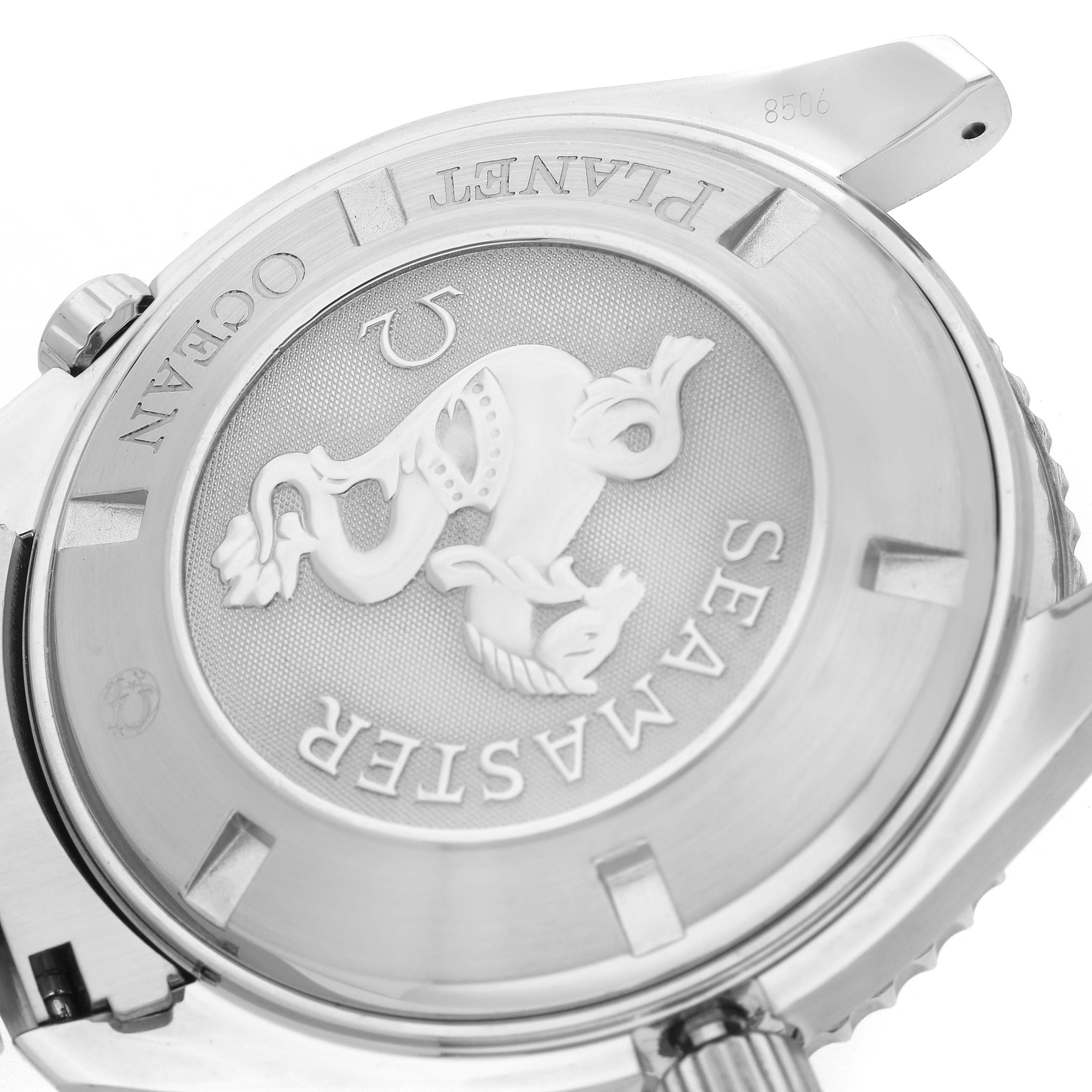 The image shows the back case of the Omega Planet Ocean 2200.51.00 Men
s Stainless Steel Black Dial 2200.51.00 Men
s Stainless Steel Black Dial watch, highlighting the Seamaster engraving and emblem.