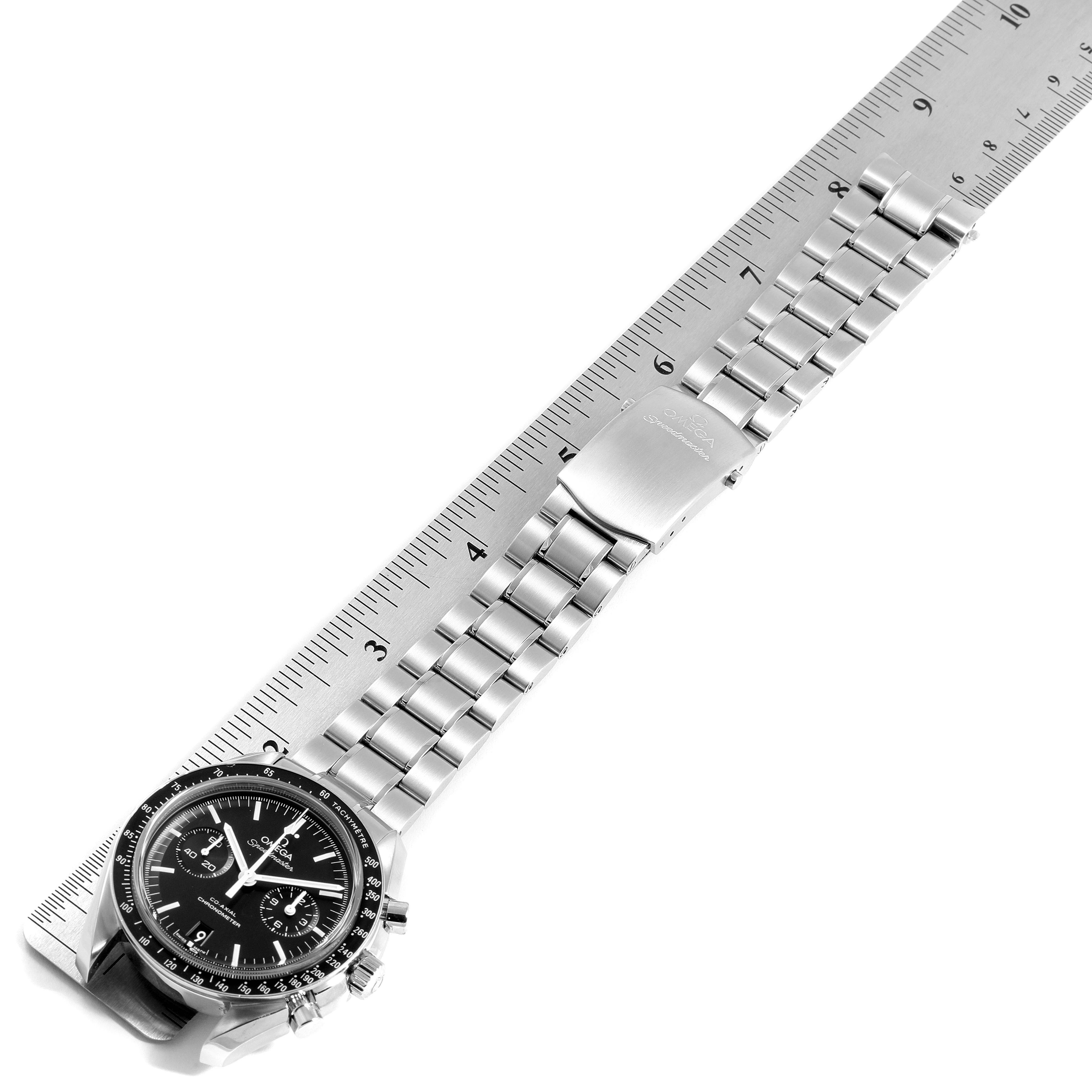 The Omega Speedmaster 311.30.44.51.01.002 Men
s Stainless Steel Black Dial 311.30.44.51.01.002 Men
s Stainless Steel Black Dial watch is shown flat, aligned with a ruler, featuring the face and steel bracelet.