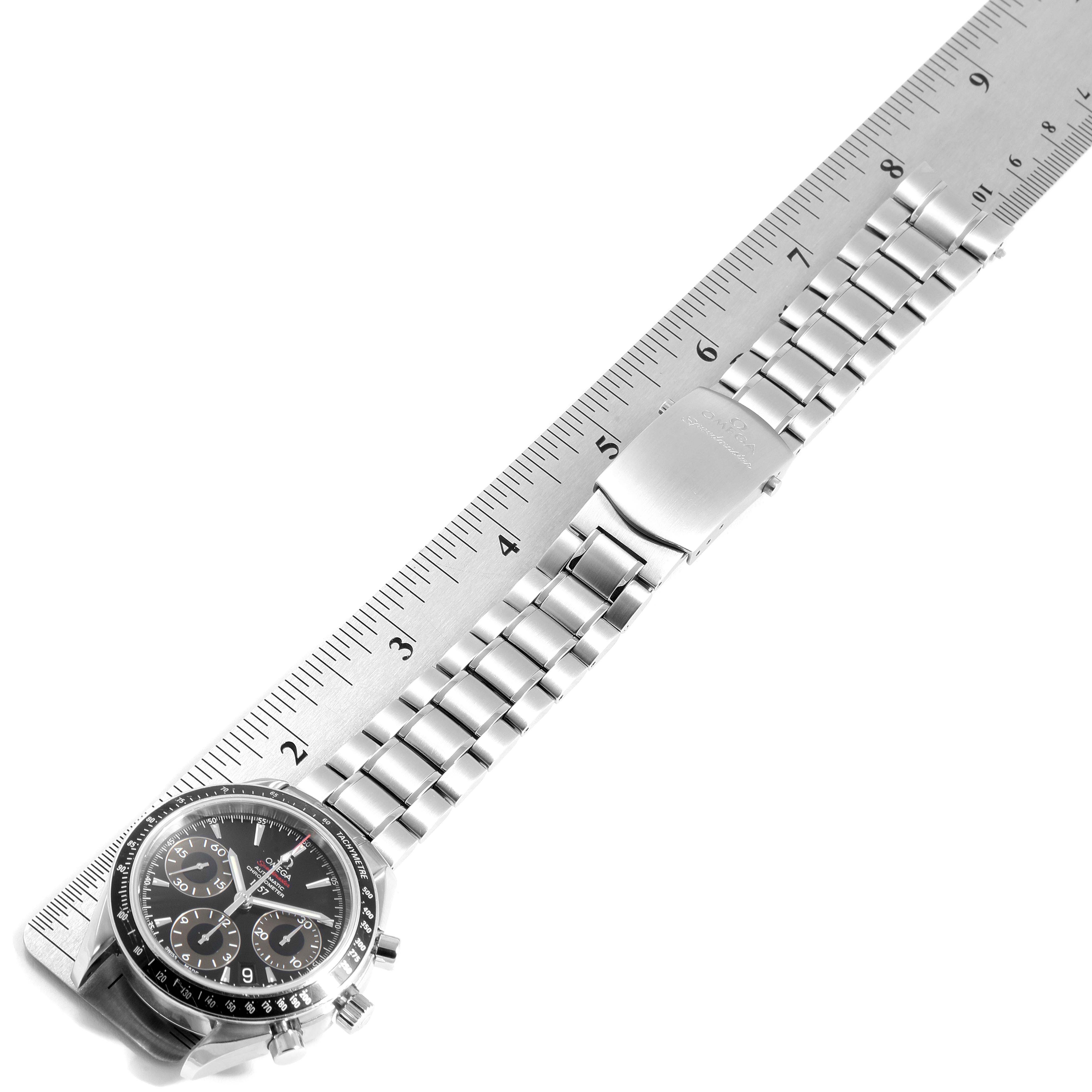 The Omega Speedmaster 323.30.40.40.01.001 Men
s Stainless Steel Black Dial 323.30.40.40.01.001 Men
s Stainless Steel Black Dial watch is shown flat with its metallic strap, next to a ruler for measurement.