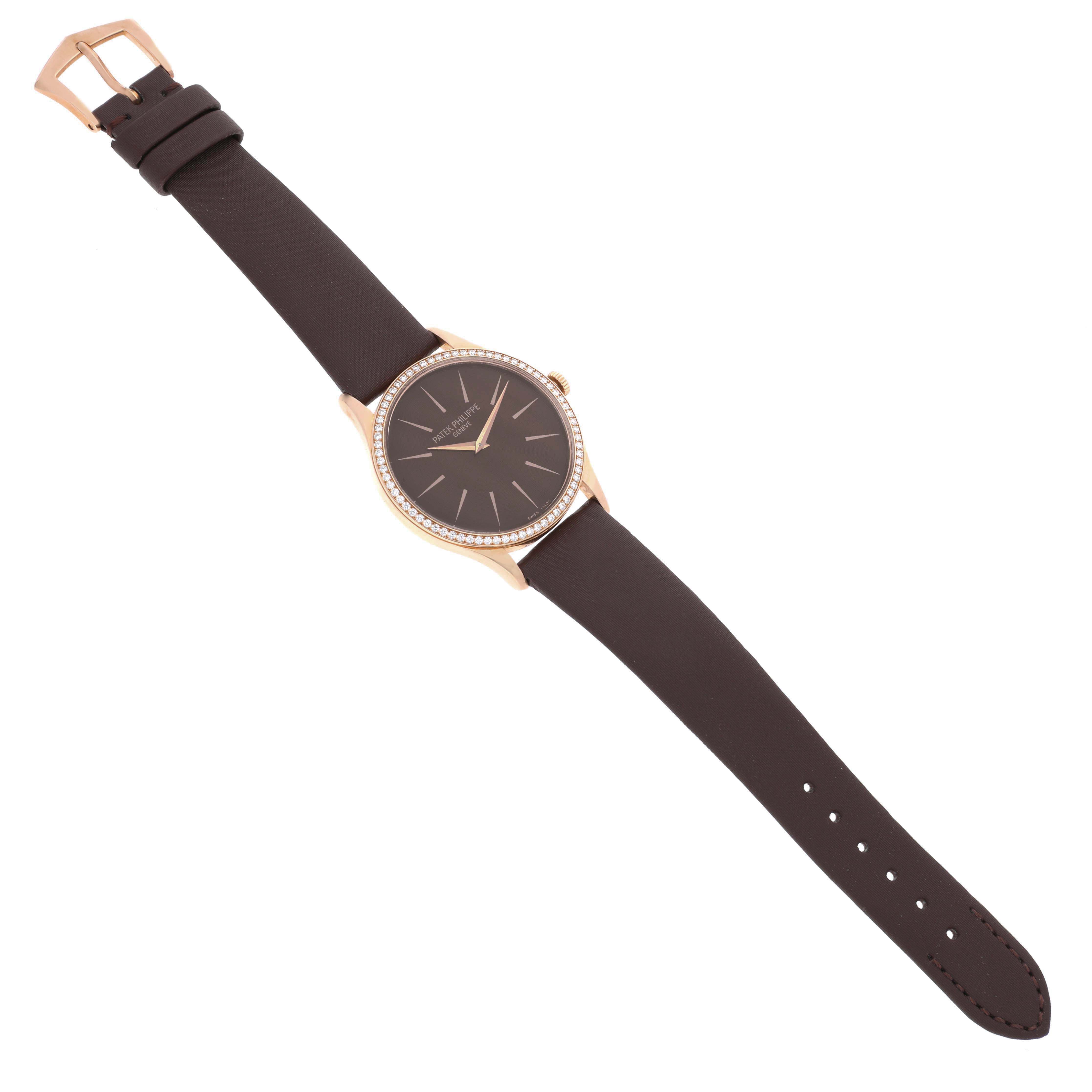 The Patek Philippe Calatrava 4897R-001 Womens Rose Gold Brown Dial watch is shown from a top-down angle, displaying its face, bezel, strap, and buckle.