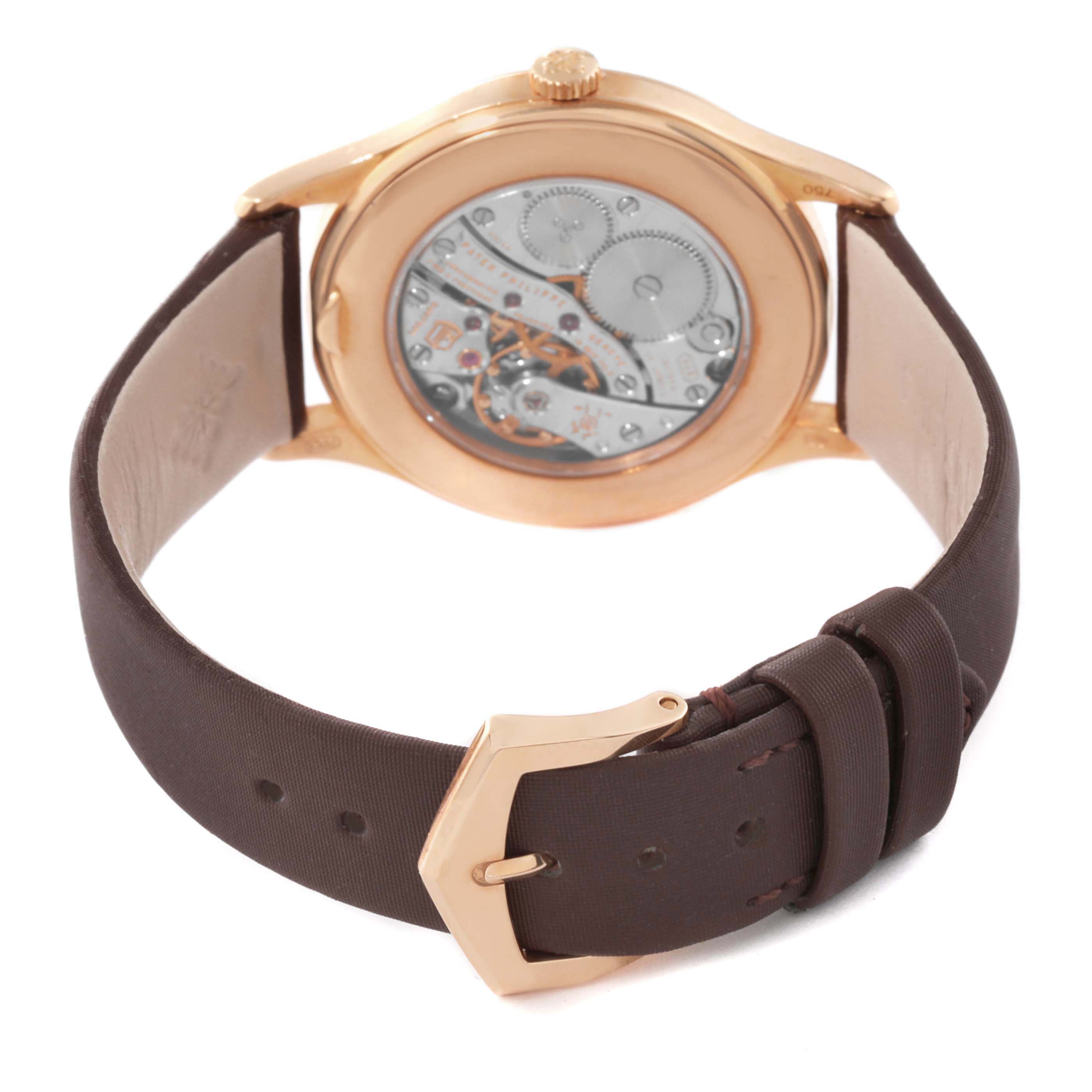 The Patek Philippe Calatrava 4897R-001 Womens Rose Gold Brown Dial is shown from the back, highlighting its mechanical movement and brown leather strap.
