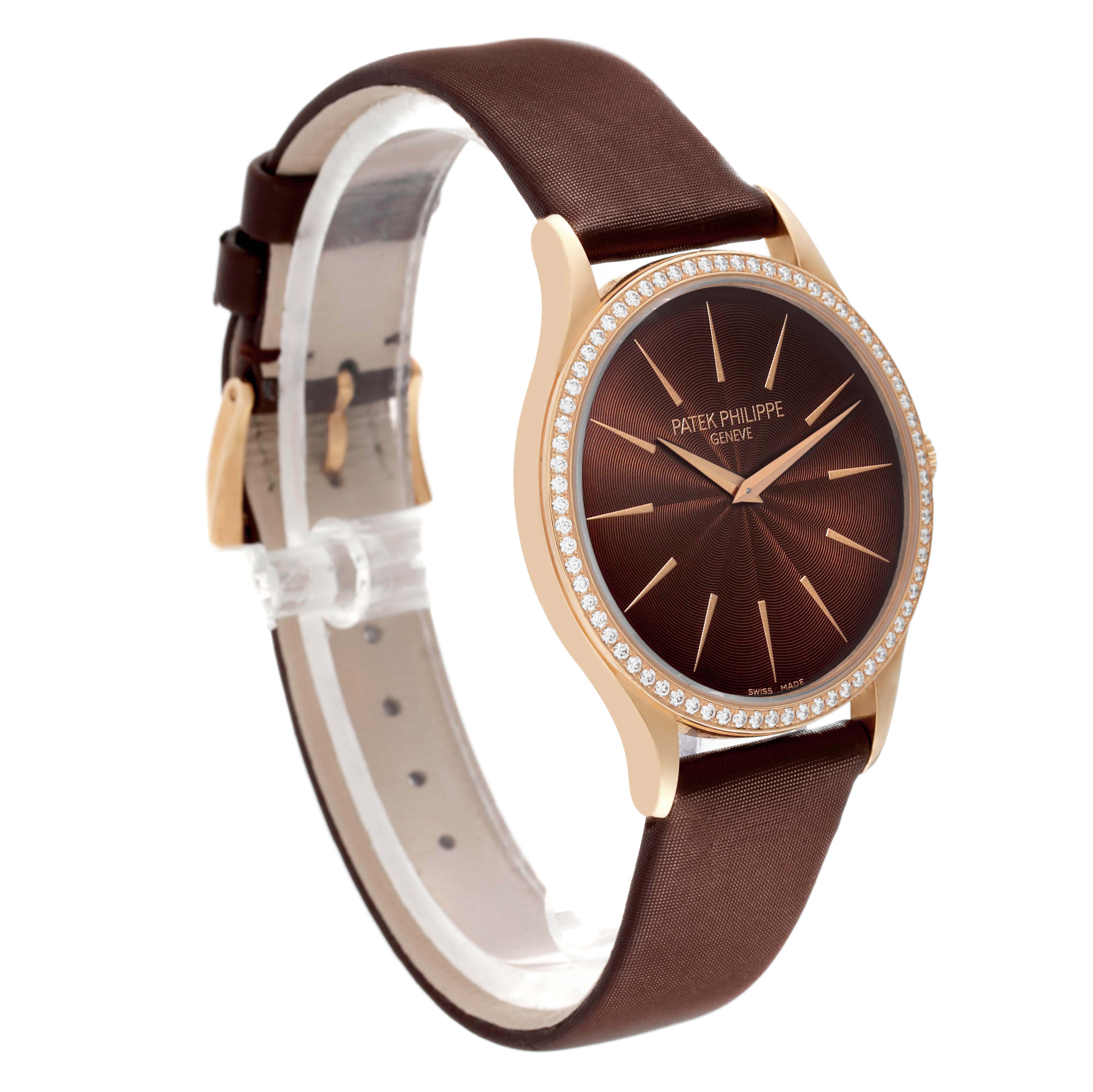 The Patek Philippe Calatrava 4897R-001 Womens Rose Gold Brown Dial is shown at a three-quarter angle, highlighting its brown dial, diamond bezel, and leather strap.