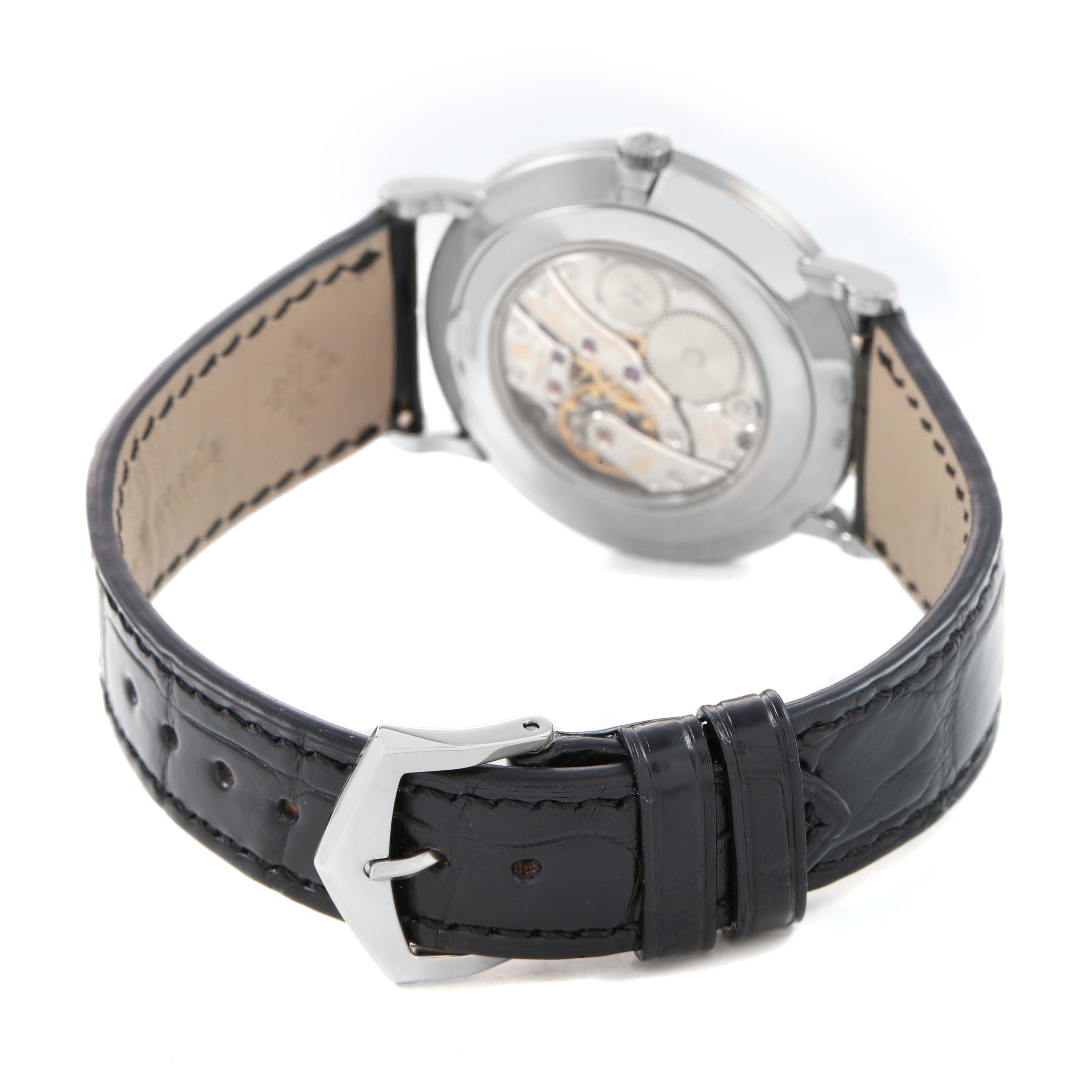 The image shows the back view of the Patek Philippe Calatrava 5119G-001 Men's White Gold White Dial watch, highlighting the movement and leather strap with buckle.