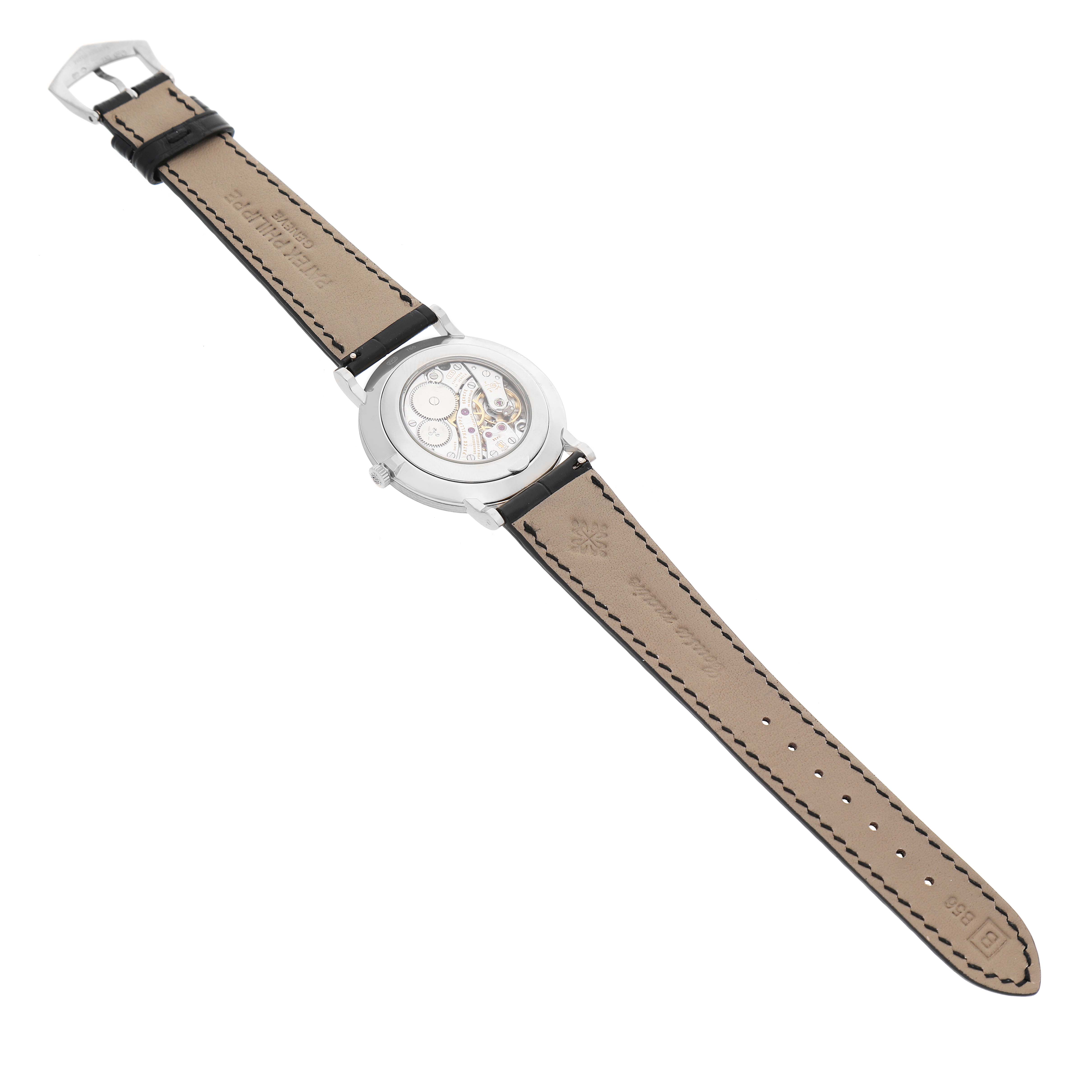 The image shows the back view of a Patek Philippe Calatrava 5119G-001 Men's White Gold White Dial watch, highlighting the leather strap and transparent case back.