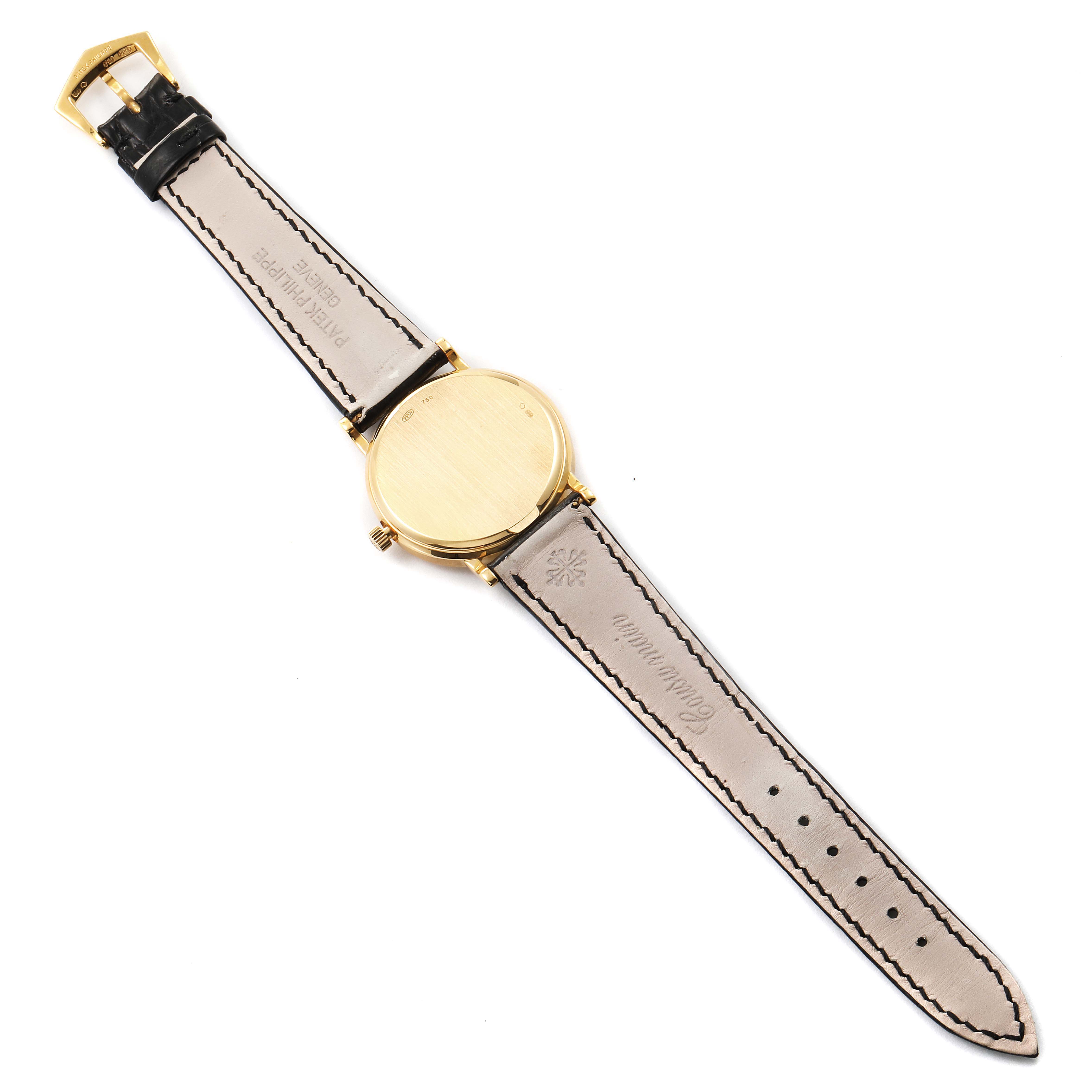 This image shows the back of the Patek Philippe Calatrava 3802/200 Men's Yellow Gold White Dial 3802/200 Men's Yellow Gold White Dial watch with a view of the gold case and leather straps.