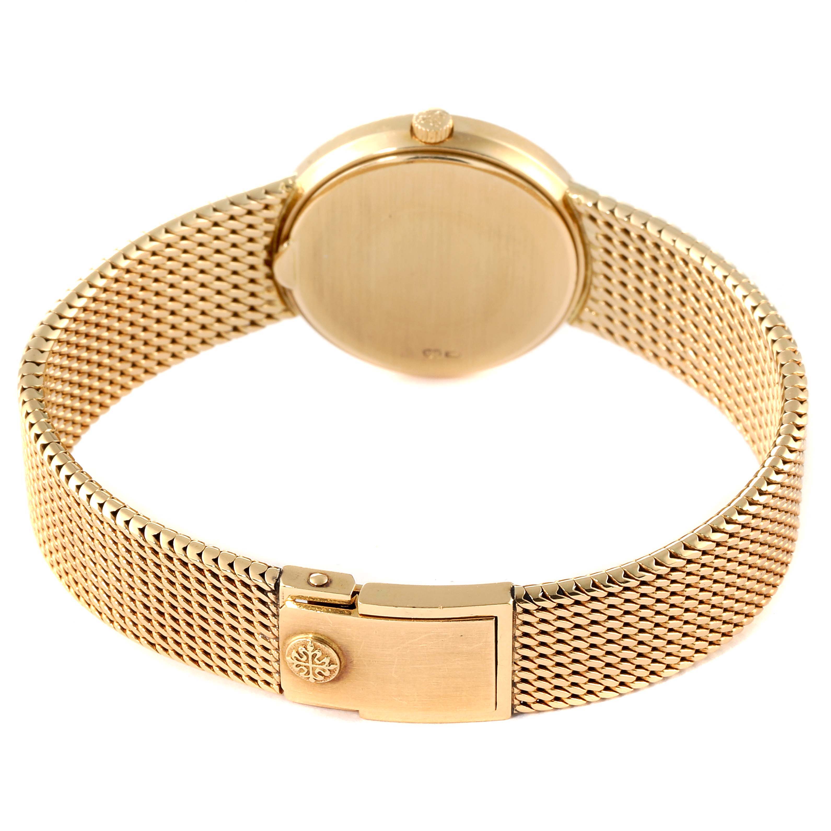 The image shows the back view of a Patek Philippe Calatrava 4819 Women's Yellow Gold White Dial 4819 Women's Yellow Gold White Dial watch, highlighting its gold mesh bracelet and clasp.