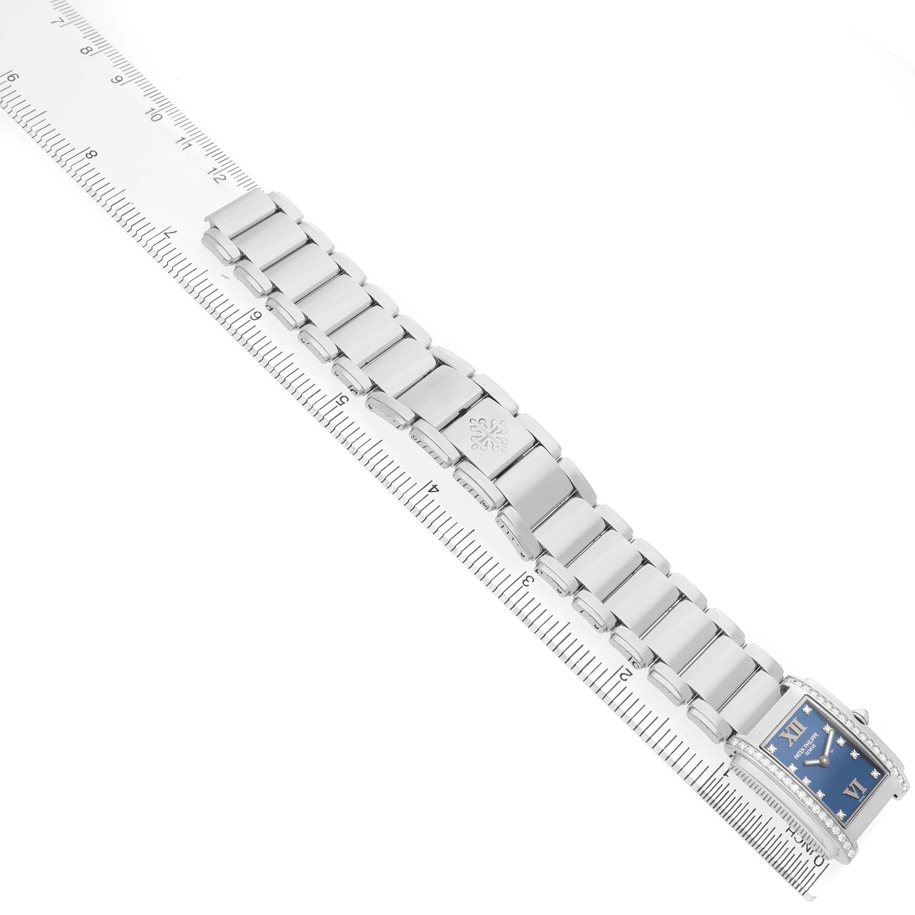 The Patek Philippe Twenty-4 4910A Women's Stainless Steel Blue Dial watch is shown from a top view, displaying the bracelet laid flat and the rectangular blue face.