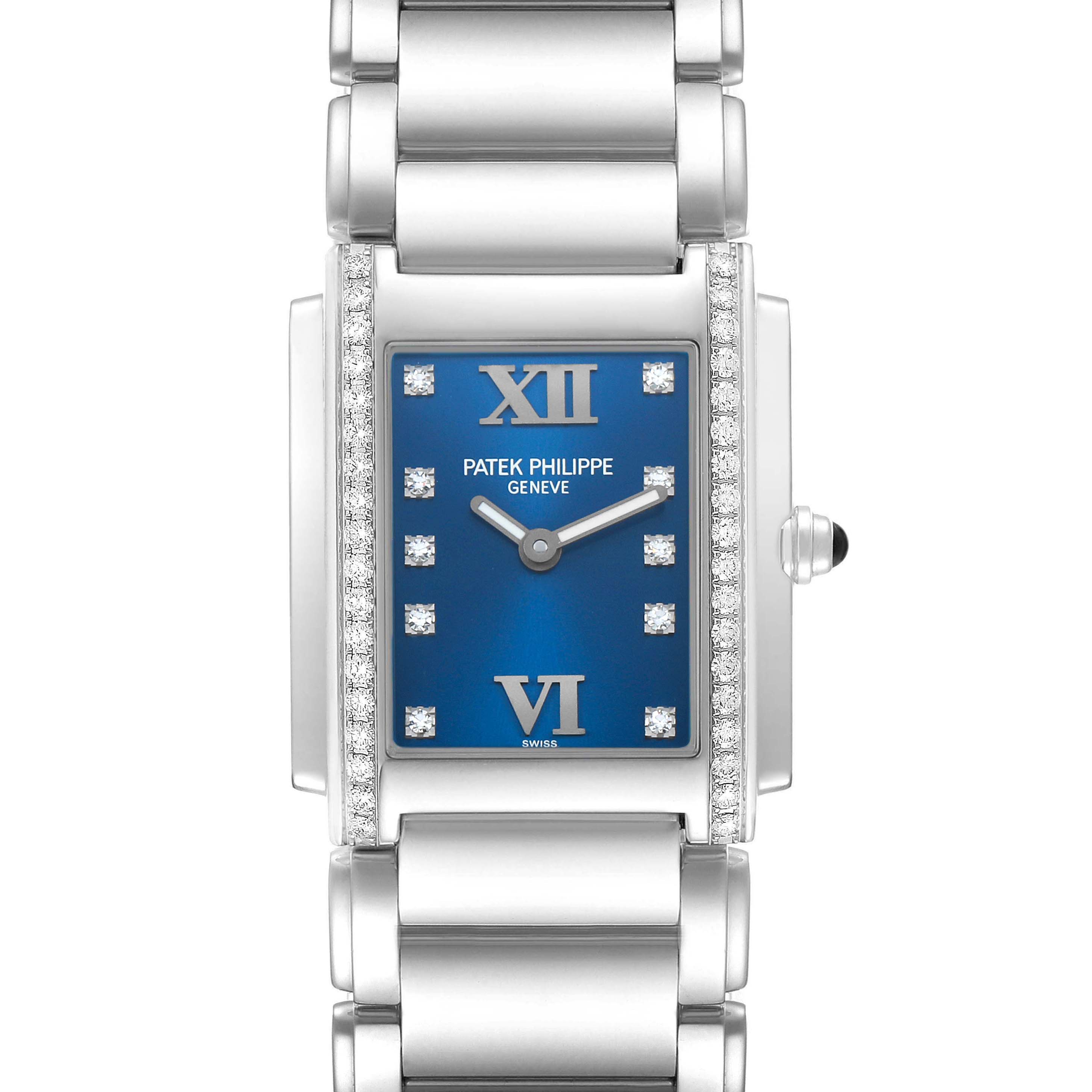 The Patek Philippe Twenty-4 4910A Women's Stainless Steel Blue Dial watch is shown from a front angle featuring its blue dial, Roman numerals, diamond markers, and metal bracelet.