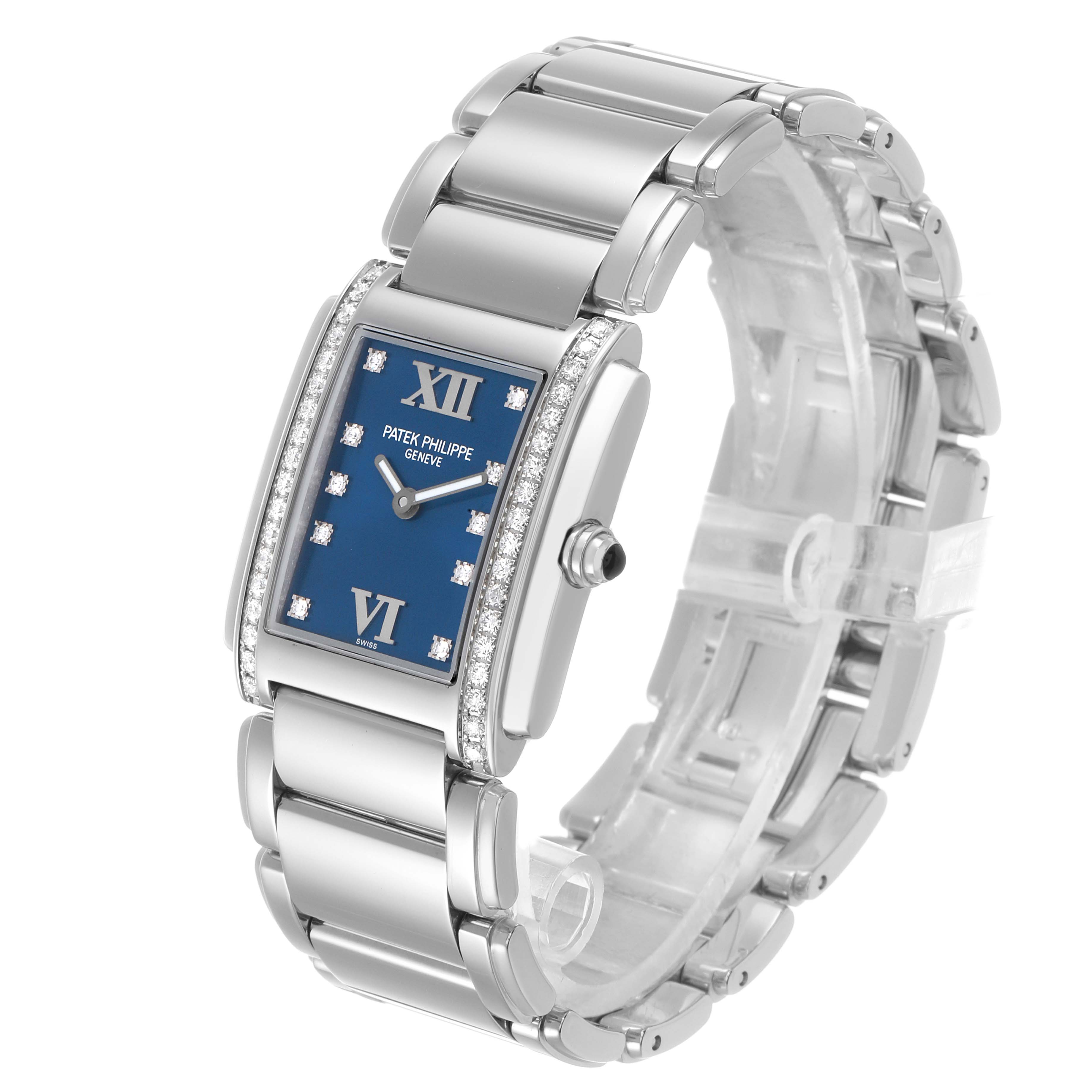 The Patek Philippe Twenty-4 4910A Women's Stainless Steel Blue Dial watch is shown at a three-quarter angle, highlighting the blue dial, diamond accents, and metal bracelet.