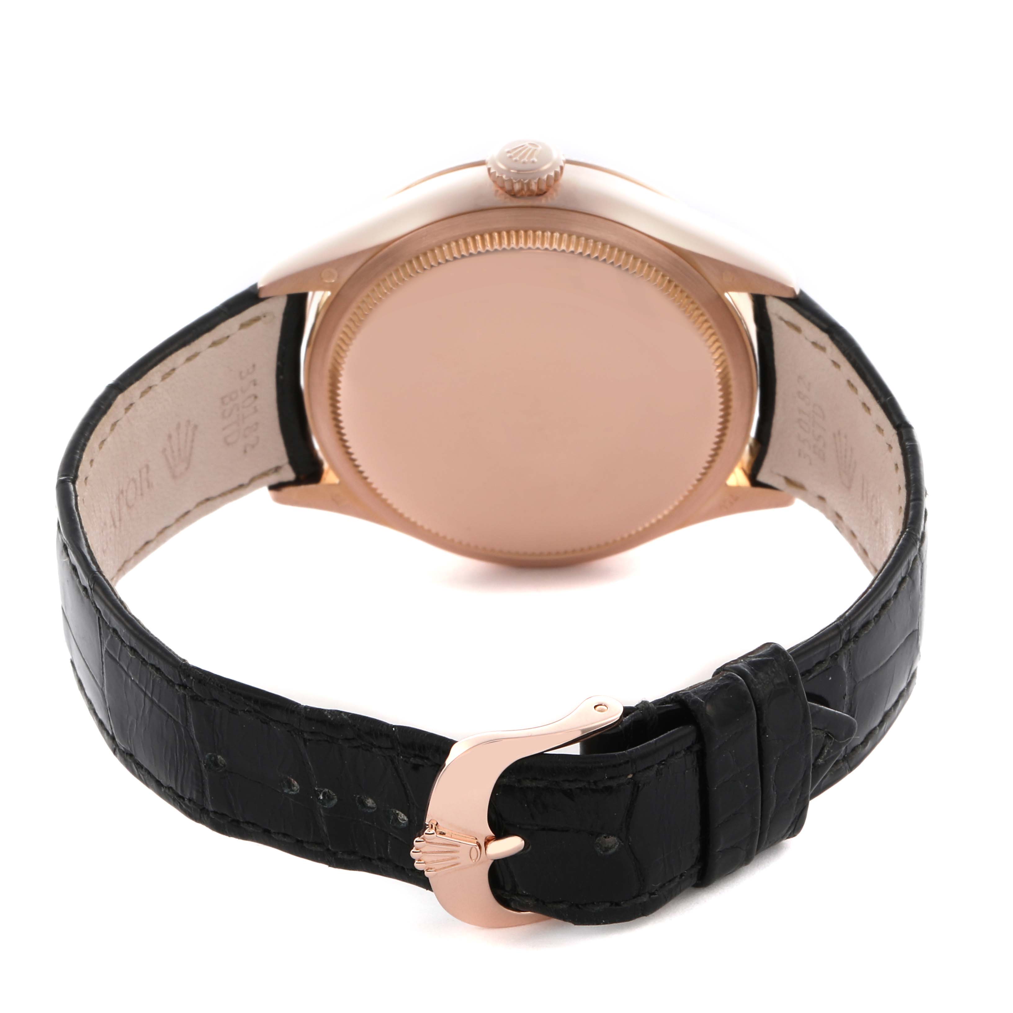 The Rolex Cellini 50515 Men
s Rose Gold Silver Dial 50515 Men
s Rose Gold Silver Dial watch is shown from the rear, highlighting the case back, crown, and leather strap with a clasp.