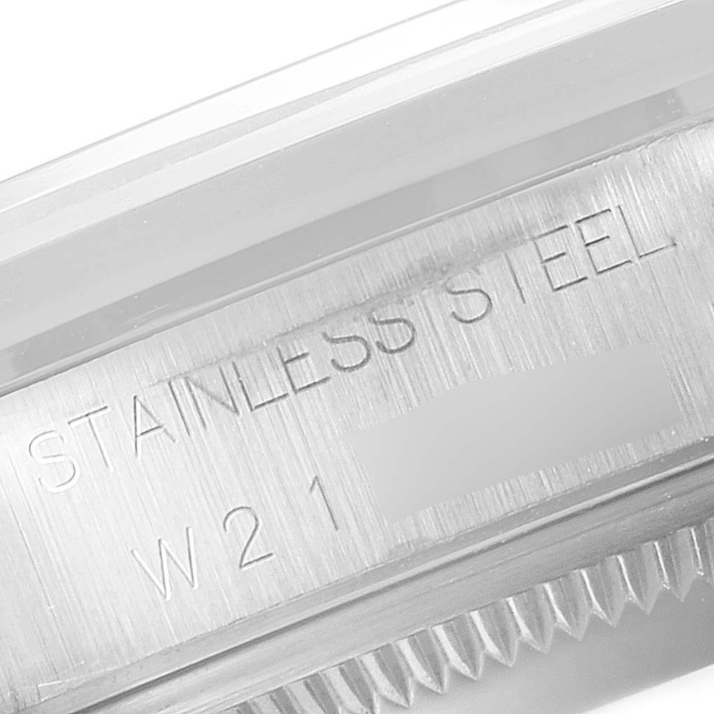 This image shows a close-up view of the serial number and "STAINLESS STEEL" engraving on the side of a Rolex Date 15200 Men's Stainless Steel Silver Dial 15200 Men's Stainless Steel Silver Dial model watch case.