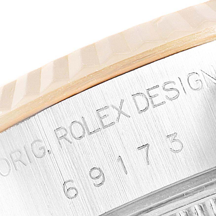 The close-up image shows the engravings on the case side of a Rolex Datejust 69173 Women's Steel and Gold (two tone) Champagne Dial 69173 Women's Steel and Gold (two tone) Champagne Dial model.