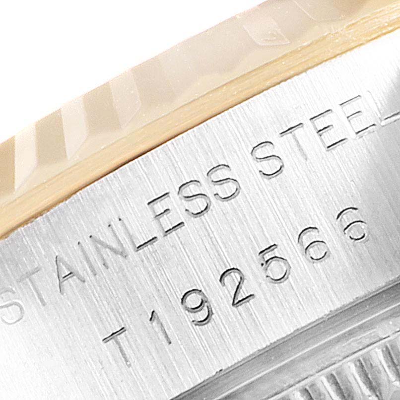 This close-up image of the Rolex Datejust 69173 Women's Steel and Gold (two tone) Champagne Dial 69173 Women's Steel and Gold (two tone) Champagne Dial watch shows a portion of the bezel and the engraved stainless steel marking.