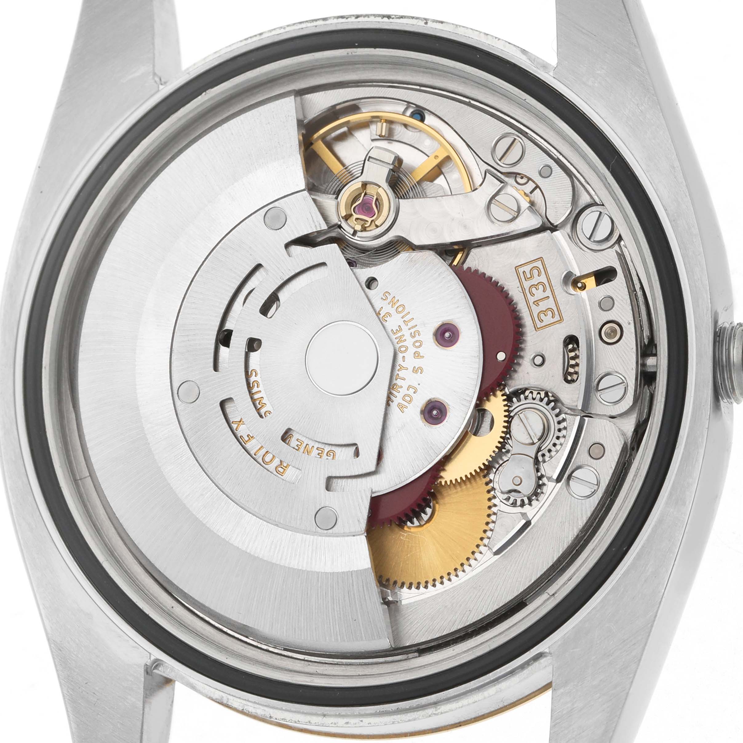 The image shows the movement and internal mechanisms of a Rolex Datejust 116233 Men's Stainless Steel Champagne Dial watch from a rear angle.