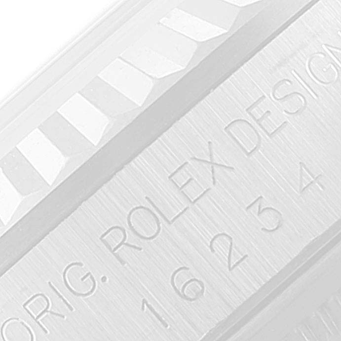 This image shows a close-up of the case and bezel of a Rolex Datejust 16234 Men's Stainless Steel Blue Dial 16234 Men's Stainless Steel Blue Dial watch, featuring the engraved "ROLEX DESIGN" text and ridged bezel pattern.