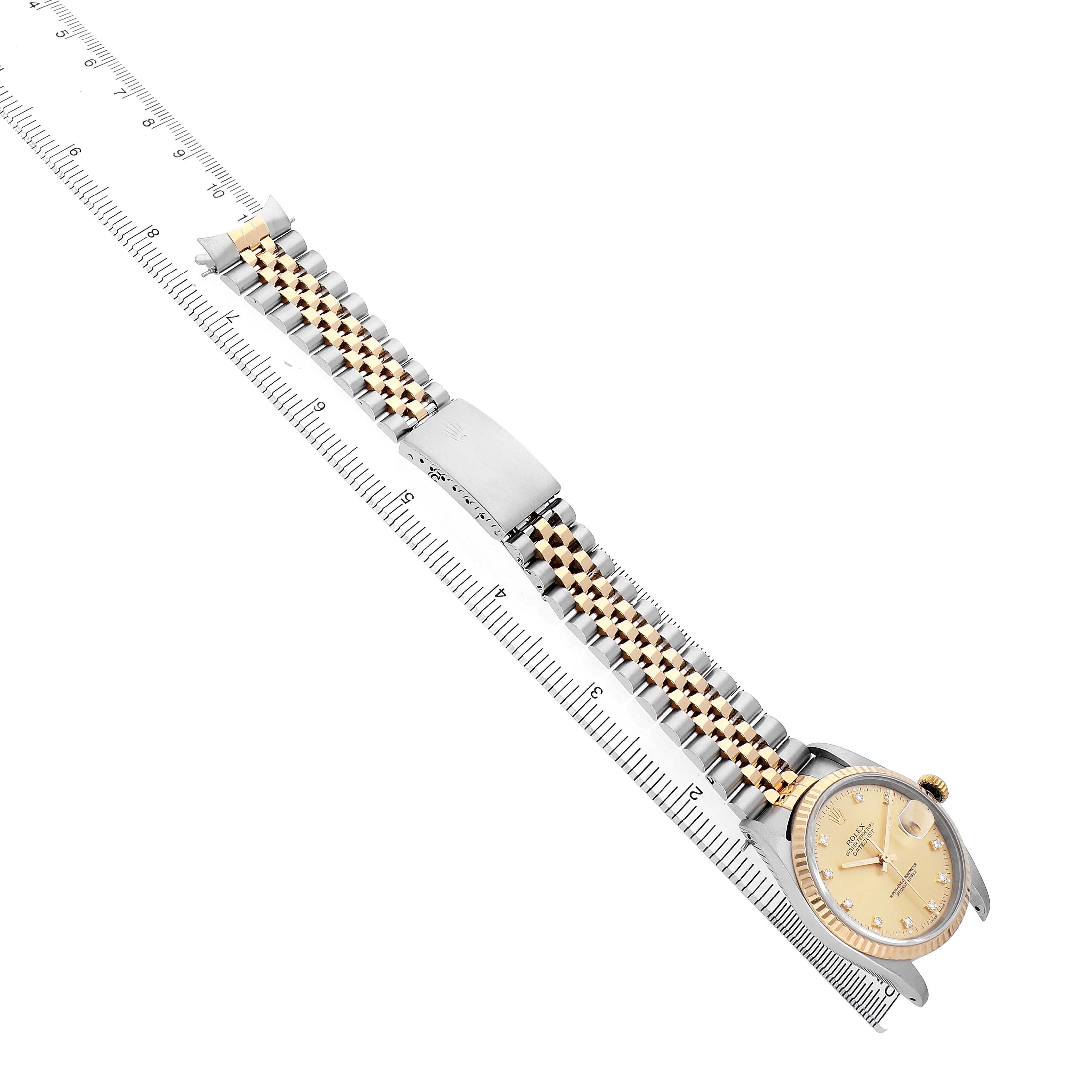 The Rolex Datejust 16233 Men's Stainless Steel Champagne Dial watch is displayed diagonally, showing the face, bracelet, and clasp next to a ruler for scale.