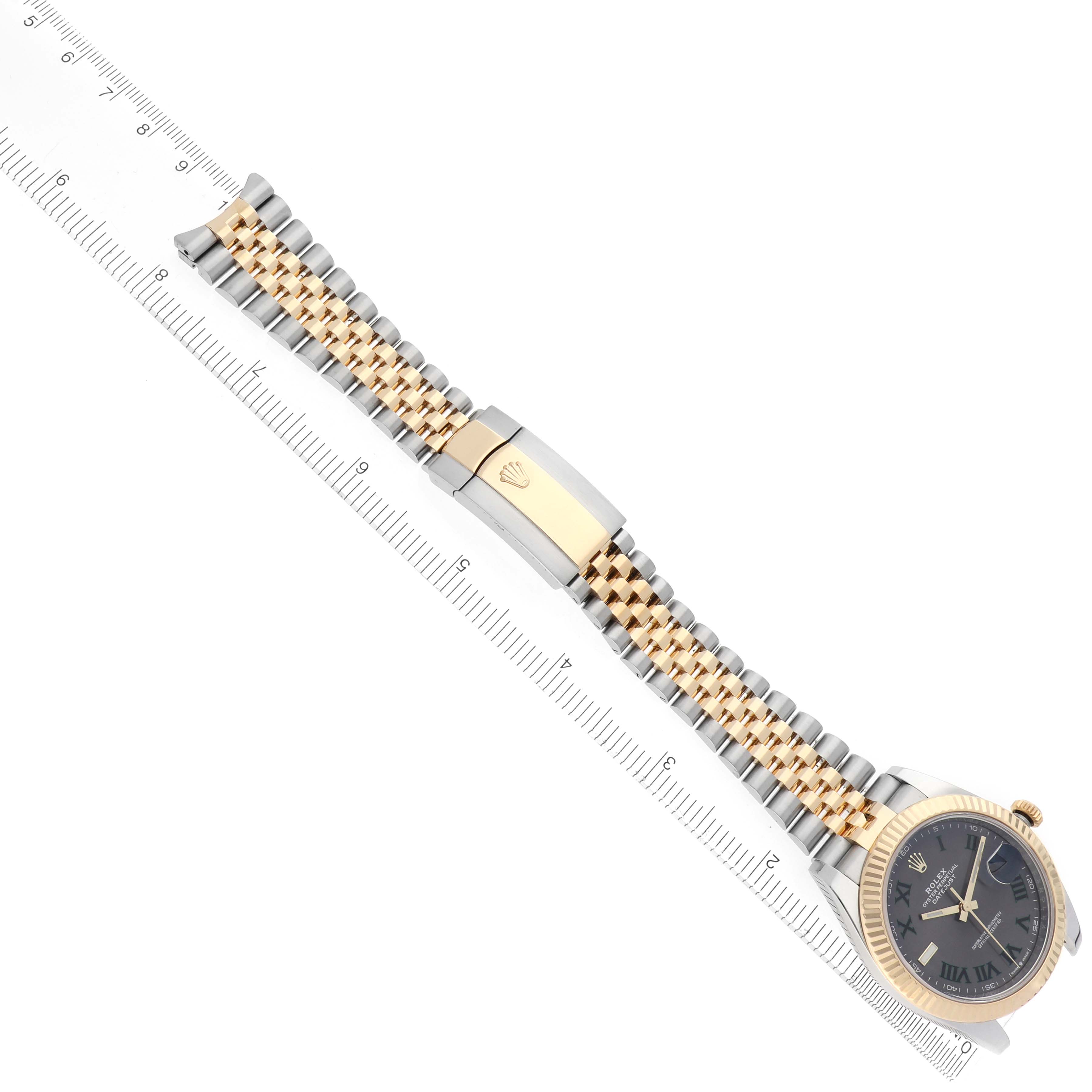 The Rolex Datejust 41 126333 Men
s Steel and Gold (two tone) Grey Dial 126333 Men
s Steel and Gold (two tone) Grey Dial is shown at an angle, displaying the dial, gold and silver bracelet, and clasp alongside a ruler.