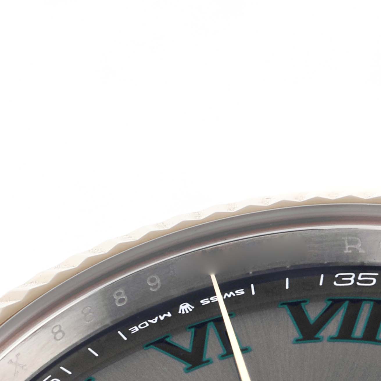 The image shows a close-up of the Rolex Datejust 41 126333 Men
s Steel and Gold (two tone) Grey Dial 126333 Men
s Steel and Gold (two tone) Grey Dial, highlighting the dial with Roman numerals, part of the bezel, and the "Swiss Made" text.