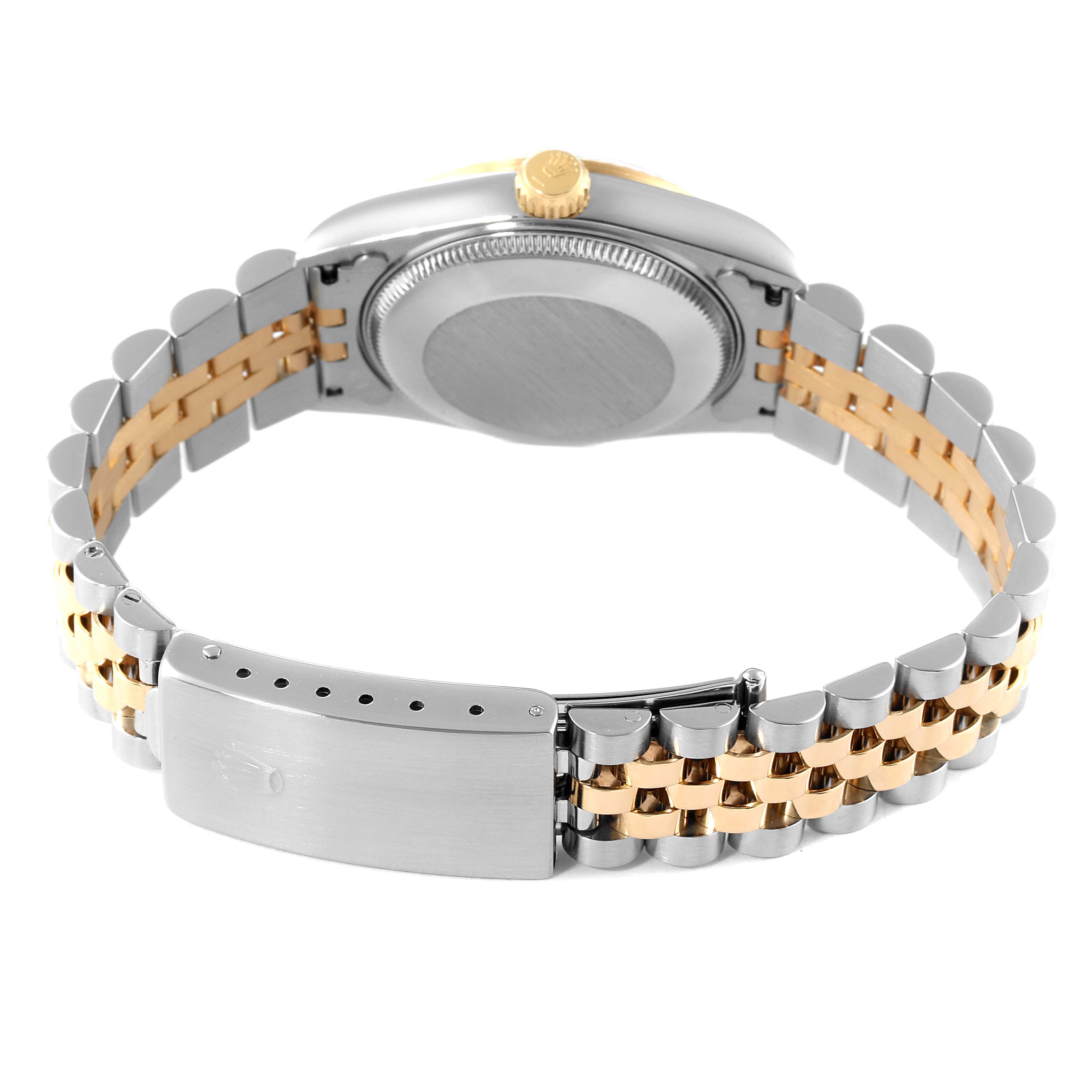 The image shows the back and clasp of a Rolex Mid-Size 68273 Women
s Steel and Gold (two tone) Champagne Dial 68273 Women
s Steel and Gold (two tone) Champagne Dial watch, highlighting the two-tone band and case.