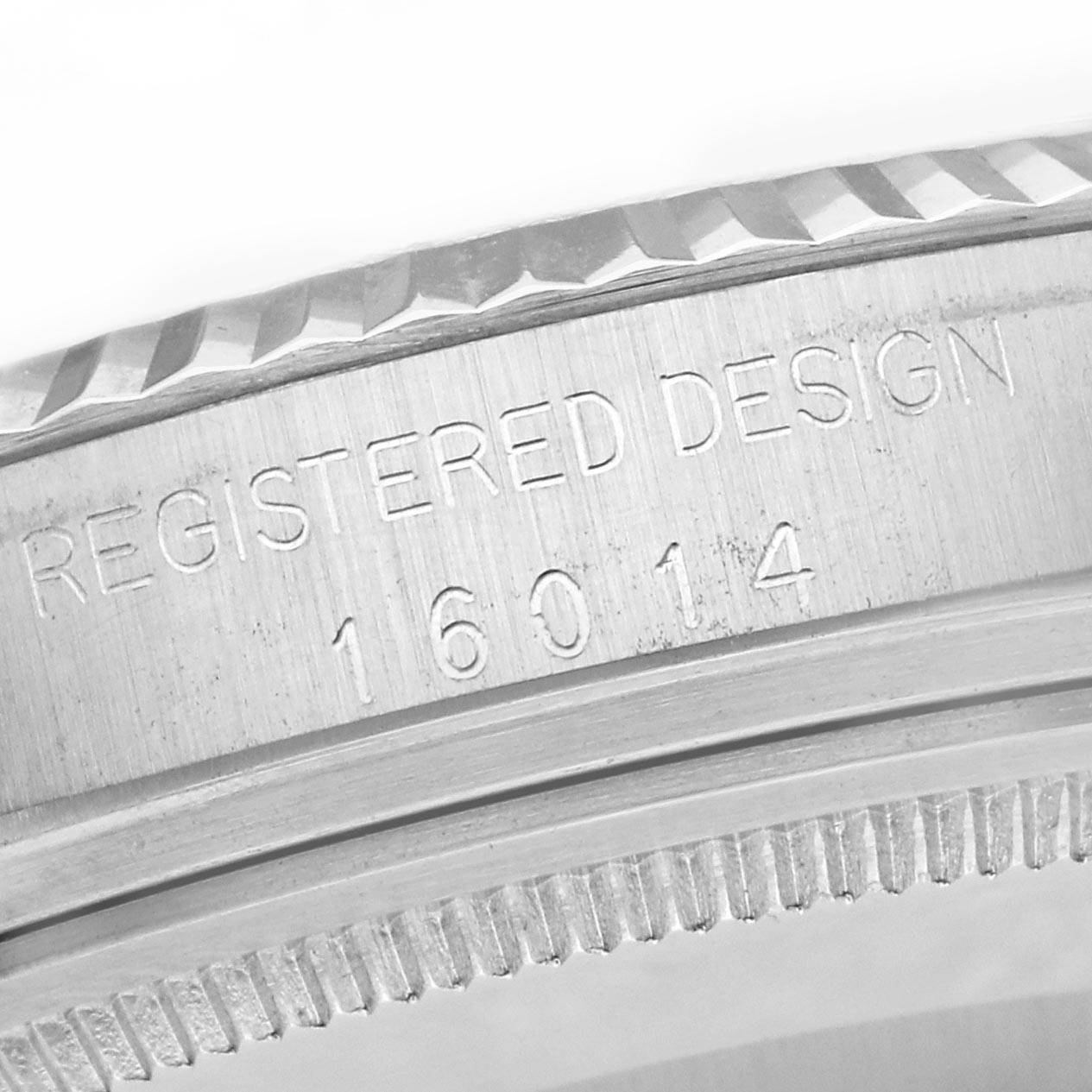 The image shows a close-up of the Rolex Datejust 16014 Men
s Stainless Steel Silver Dial 16014 Men
s Stainless Steel Silver Dial
s case side, highlighting the "Registered Design 16014" engraving.