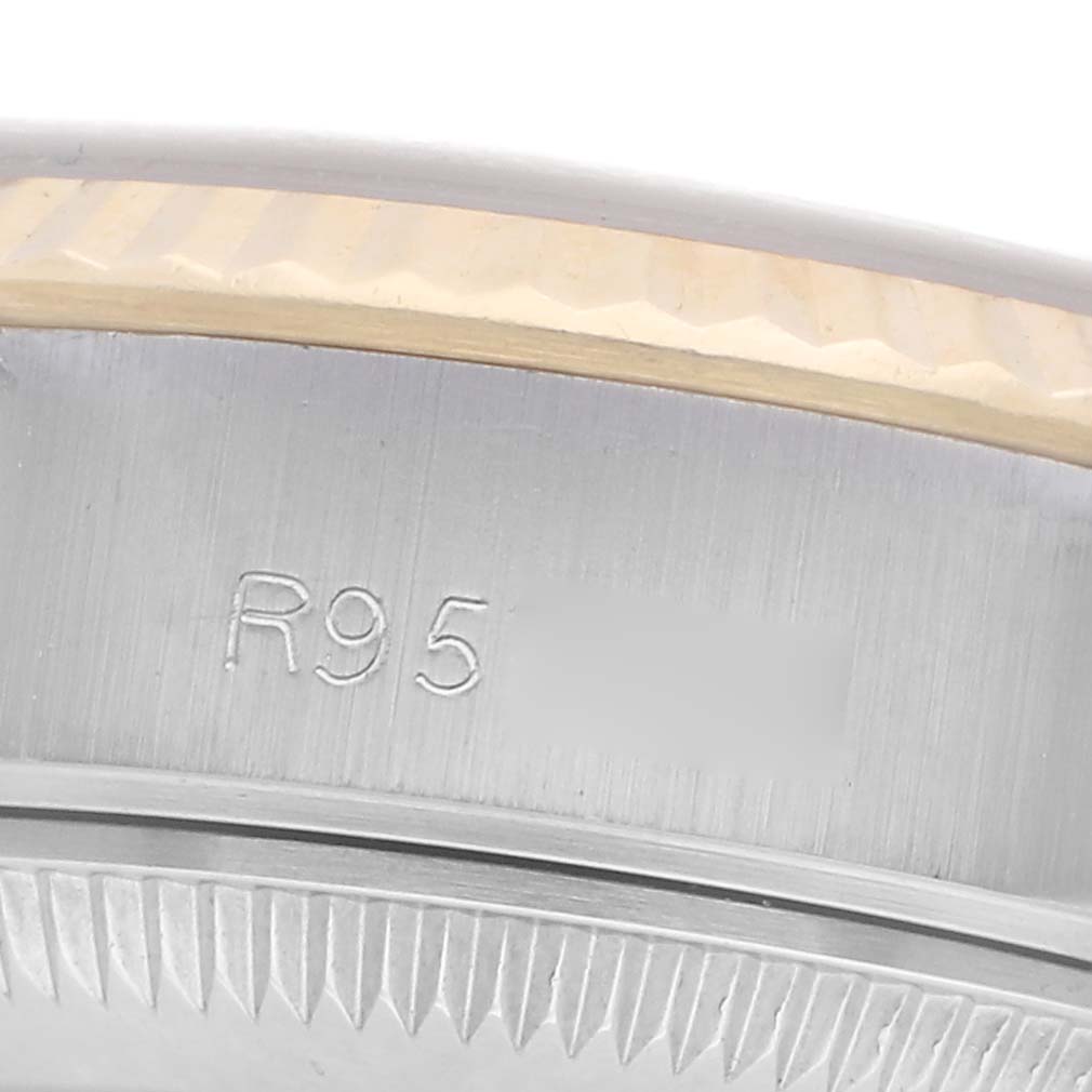 The image shows a close-up of the bezel and case edge of a Rolex Datejust 69173 Women
s Steel and Gold (two tone) Champagne Dial 69173 Women
s Steel and Gold (two tone) Champagne Dial, revealing the watch
s model engraving.