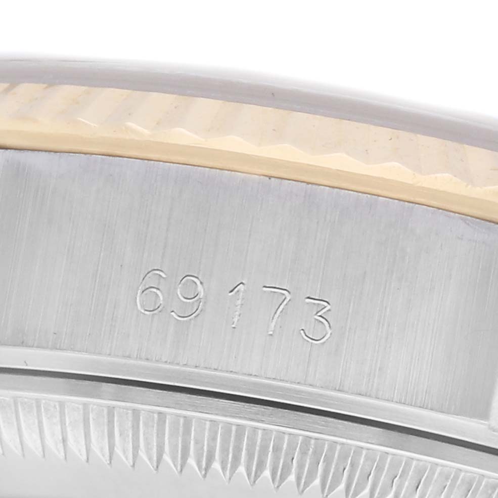 The image shows a close-up angle of the Rolex Datejust 69173 Women
s Steel and Gold (two tone) Champagne Dial 69173 Women
s Steel and Gold (two tone) Champagne Dial model
s serial number and bezel.