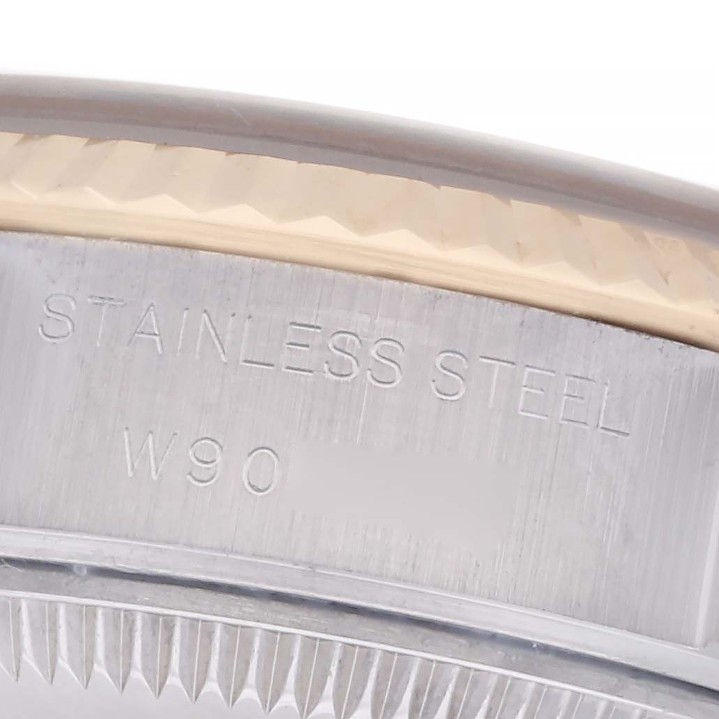 The image shows a close-up angle of a Rolex Datejust 69173 Women's Steel and Gold (two tone) Champagne Dial 69173 Women's Steel and Gold (two tone) Champagne Dial watch's stainless steel case with part of the fluted bezel visible.