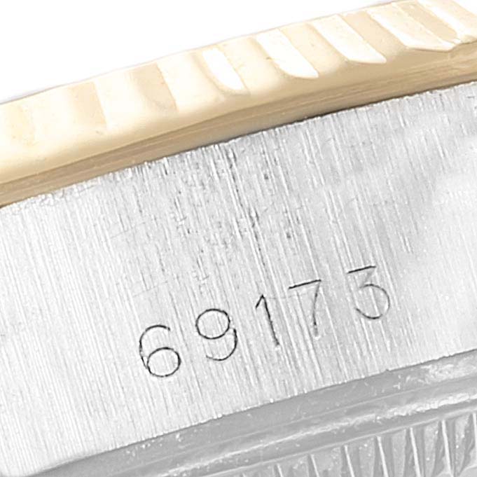 This image shows a close-up of the Rolex Datejust 69173 Women
s Steel and Gold (two tone) Champagne Dial 69173 Women
s Steel and Gold (two tone) Champagne Dial model
s bezel and model number "69173" engraved on its case.