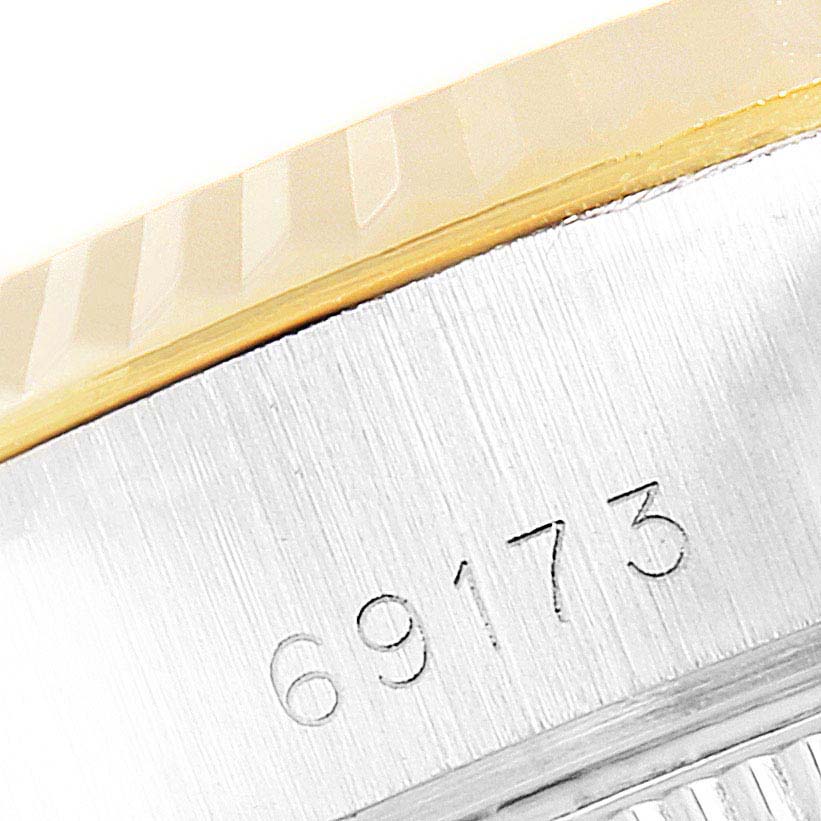 The image shows a close-up of the edge of a Rolex Datejust 69173 Women
s Steel and Gold (two tone) Champagne Dial 69173 Women
s Steel and Gold (two tone) Champagne Dial watch bezel and case, including the model number 69173.