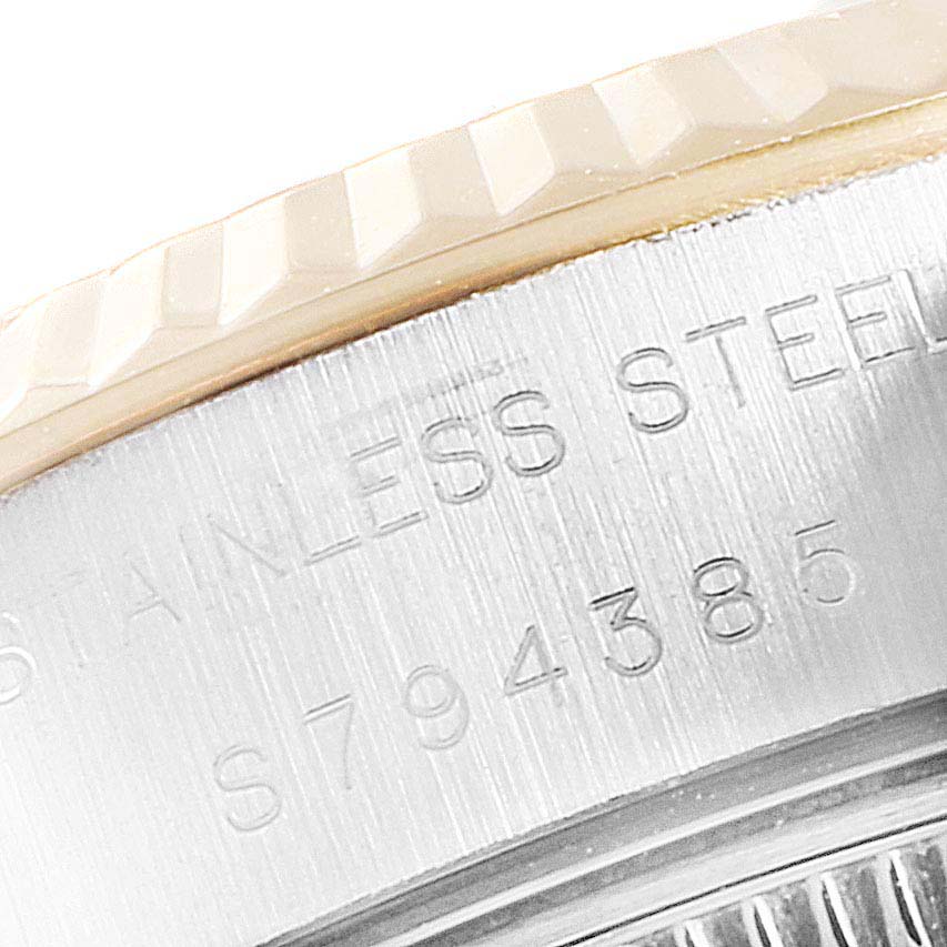 This is a close-up of the case side of the Rolex Datejust 69173 Women
s Steel and Gold (two tone) White Dial 69173 Women
s Steel and Gold (two tone) White Dial watch, showing the markings "STAINLESS STEEL" and a serial number.