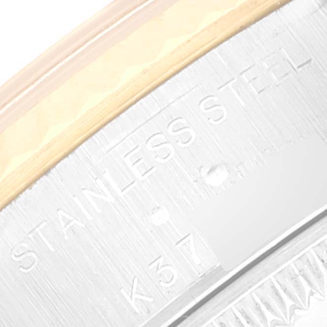 This close-up image shows the case back edge of a Rolex Datejust 79173 Women's Steel and Gold (two tone) Silver Dial 79173 Women's Steel and Gold (two tone) Silver Dial watch, highlighting the "Stainless Steel" engraving.