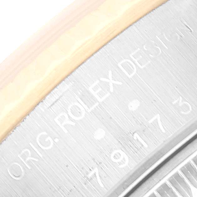 The image shows a close-up of the inscription on the case back of a Rolex Datejust 79173 Women's Steel and Gold (two tone) Silver Dial 79173 Women's Steel and Gold (two tone) Silver Dial watch.