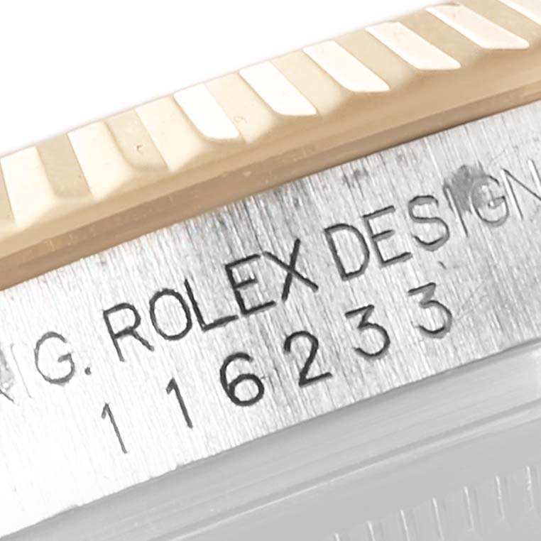 This close-up image shows the reference number and fluted bezel of the Rolex Datejust 116233 Men's Steel and Gold (two tone) Silver Dial 116233 Men's Steel and Gold (two tone) Silver Dial watch.