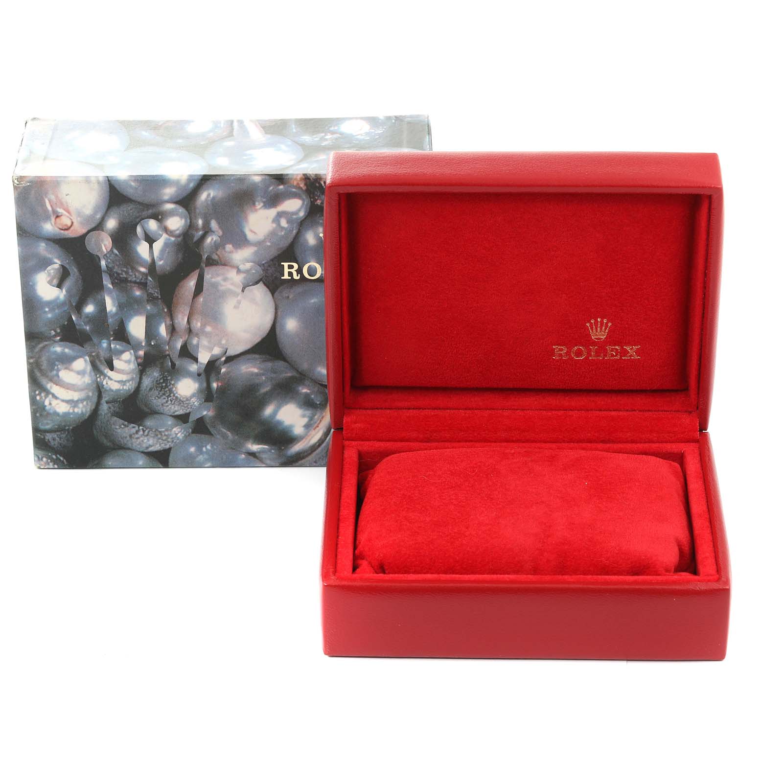 The image displays an open red Rolex watch box with the cushion inside and an outer packaging box in the background.