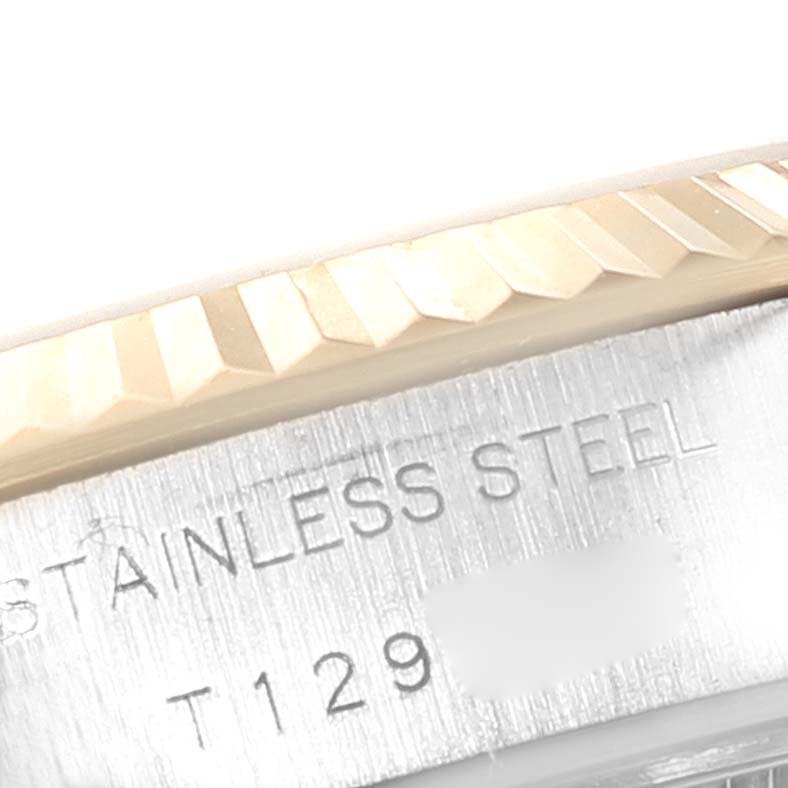 The image shows a close-up angle of the fluted bezel and part of the case back of the Rolex Datejust 69173 Women's Steel and Gold (two tone) White Dial 69173 Women's Steel and Gold (two tone) White Dial watch, highlighting the "STAINLESS STEEL" engraving.