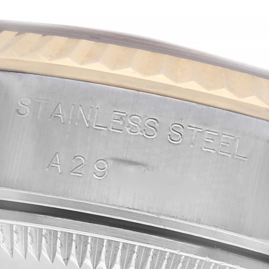 This image shows a close-up of the edge and bezel of a Rolex Datejust 79173 Women's Steel and Gold (two tone) White Dial 79173 Women's Steel and Gold (two tone) White Dial watch, highlighting the stainless steel and engraving.