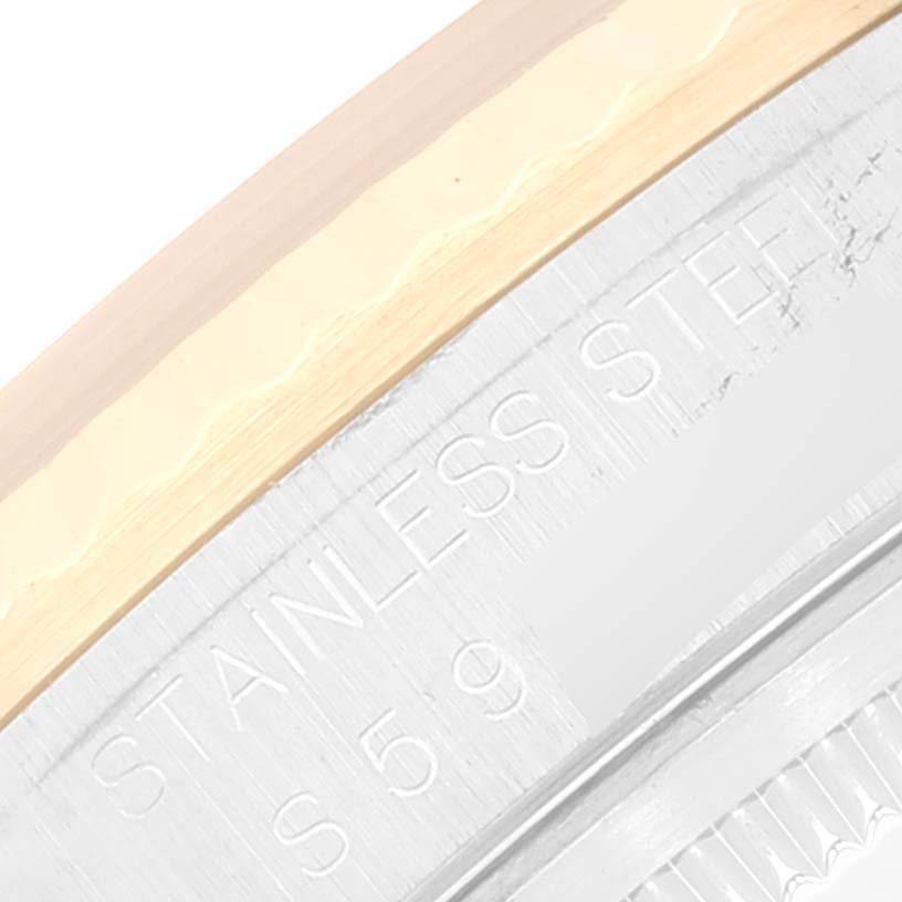 This image shows a close-up of the stainless steel and gold bezel of a Rolex Datejust 16233 Men's Steel and Gold (two tone) White Dial 16233 Men's Steel and Gold (two tone) White Dial watch.