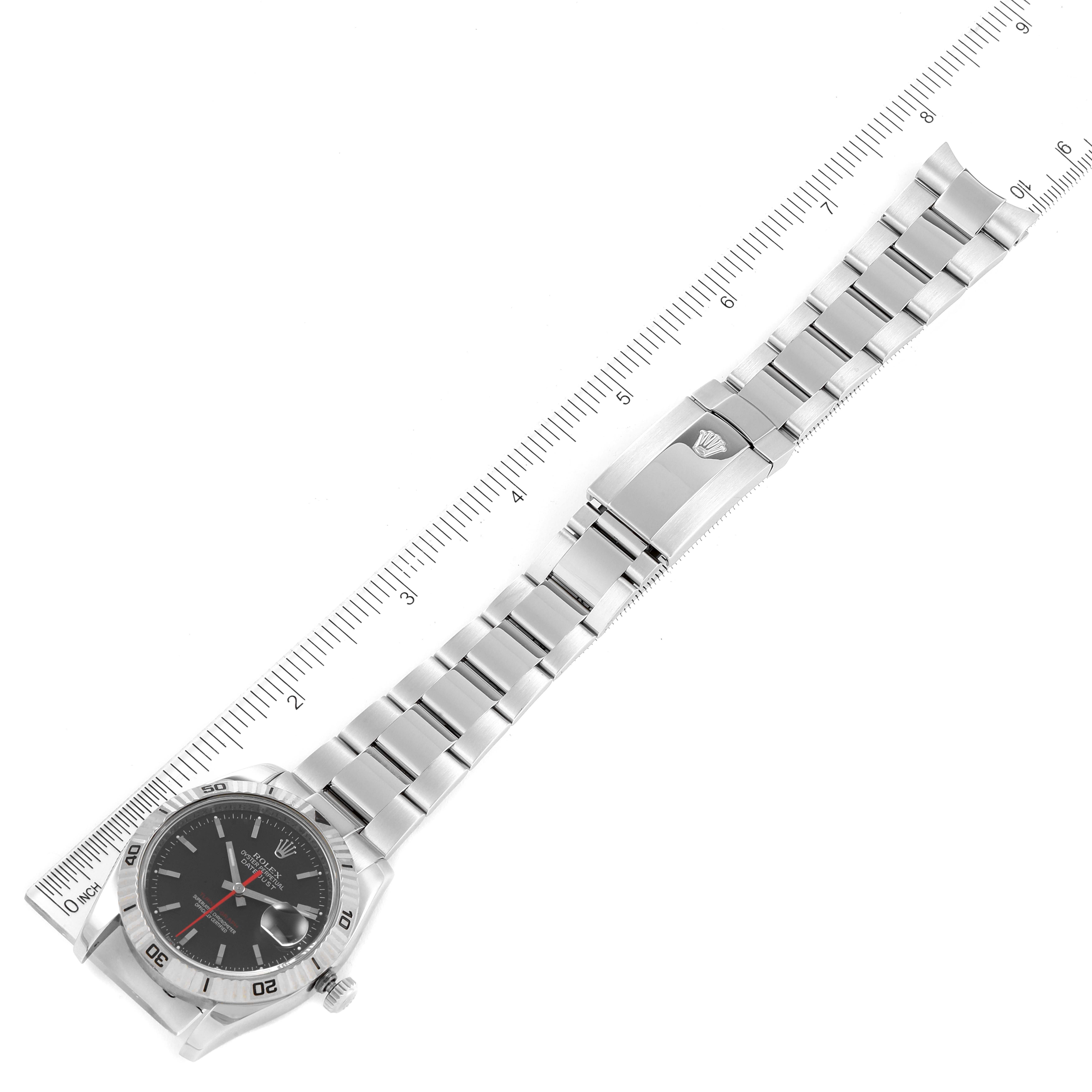 This image shows a top view of the Rolex Turn-o-Graph 116264 Men
s Stainless Steel Black Dial 116264 Men
s Stainless Steel Black Dial watch, including its face, bezel, and bracelet against a measuring ruler.