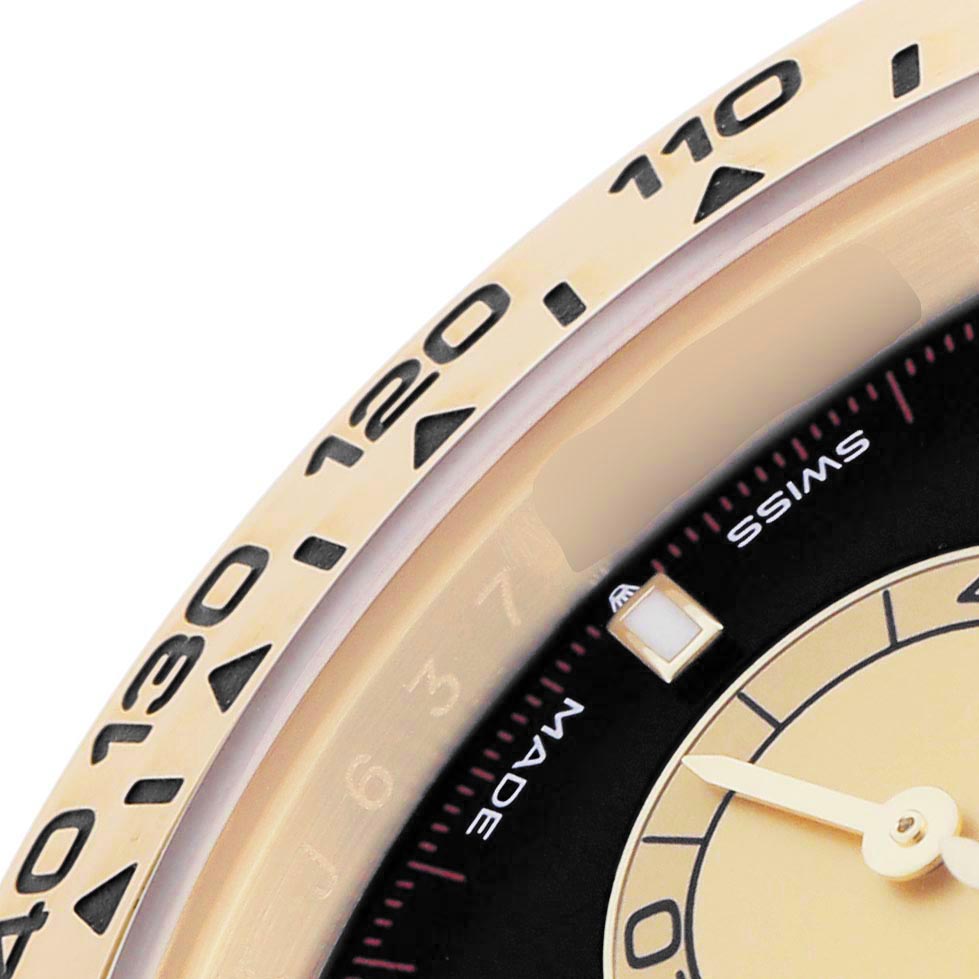 The image shows a close-up of the bezel and partial dial of a Rolex Daytona 126508 Men
s Yellow Gold Black Dial 126508 Men
s Yellow Gold Black Dial, highlighting the tachymetric scale and hour markers.