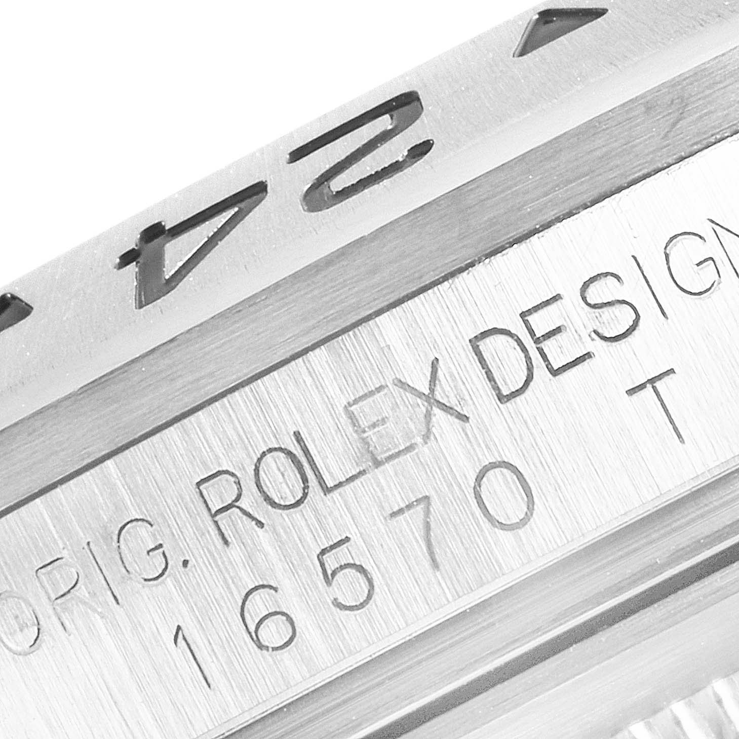 Close-up view of the side of a Rolex Explorer 16570 Men's Stainless Steel White Dial 16570 Men's Stainless Steel White Dial watch bezel and engraved serial number.