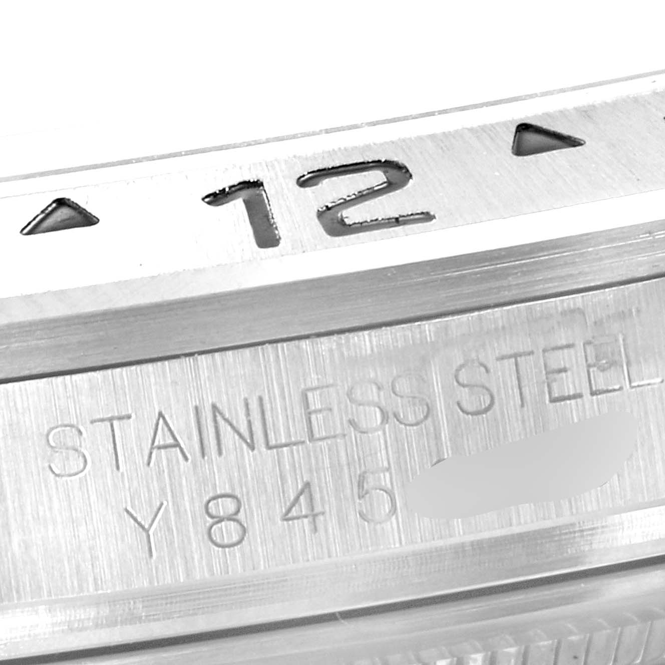 The image shows a close-up of the 12 o'clock marker and stainless steel inscription on a Rolex Explorer 16570 Men's Stainless Steel White Dial 16570 Men's Stainless Steel White Dial watch.