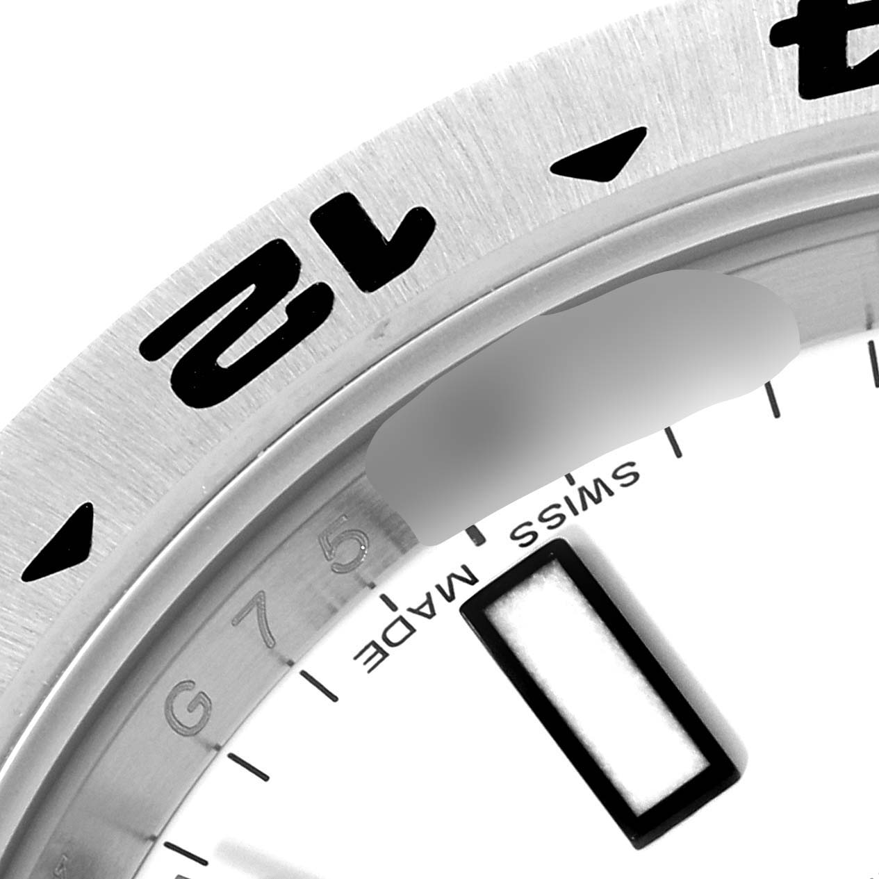 The image shows a close-up of the bezel and part of the dial of a Rolex Explorer 216570 Men
s Stainless Steel White Dial 216570 Men
s Stainless Steel White Dial watch.