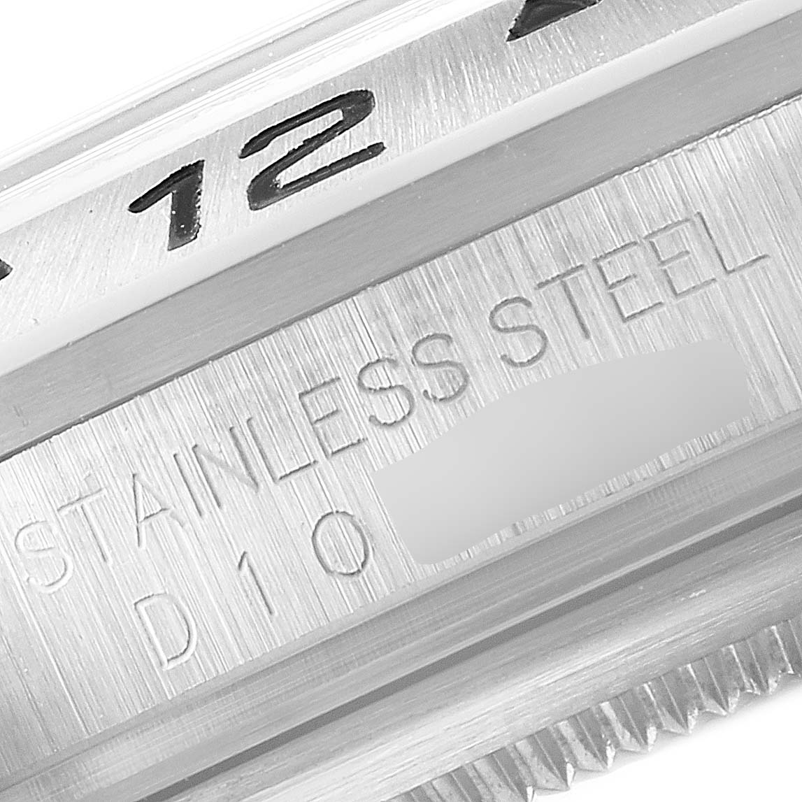 The image shows a close-up of the stainless steel bezel and part of the engraved details of a Rolex Explorer 16570 Men
s Stainless Steel Black Dial 16570 Men
s Stainless Steel Black Dial watch.