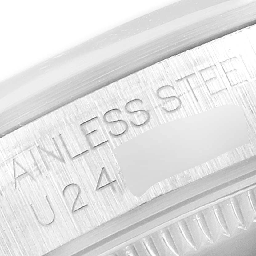 The image shows a close-up of the stainless steel case back edge of a Mid-Size Rolex watch with engraved text.