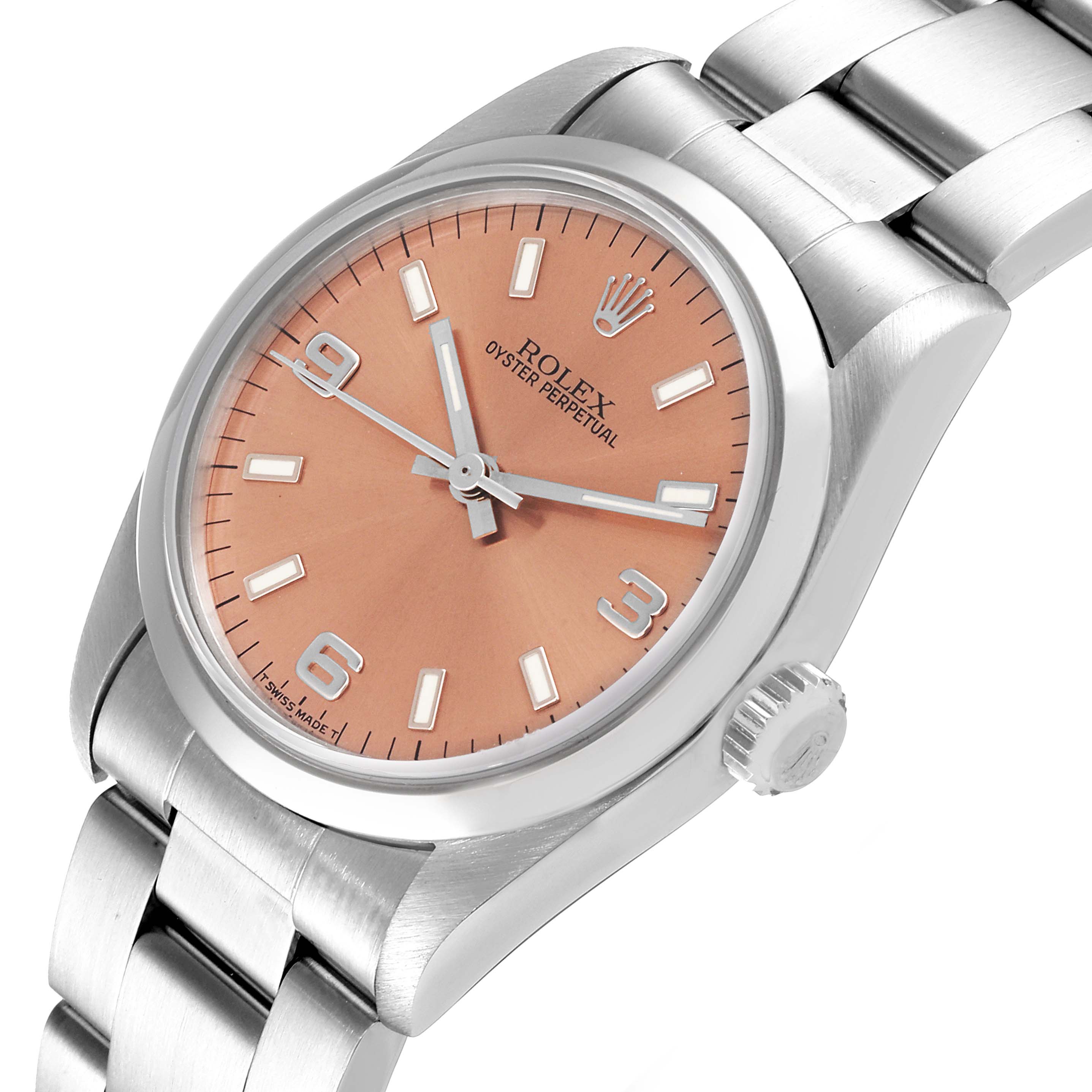 The image shows a mid-size Rolex Oyster Perpetual watch at an angled top view, displaying the face, dial, bezel, and part of the bracelet.