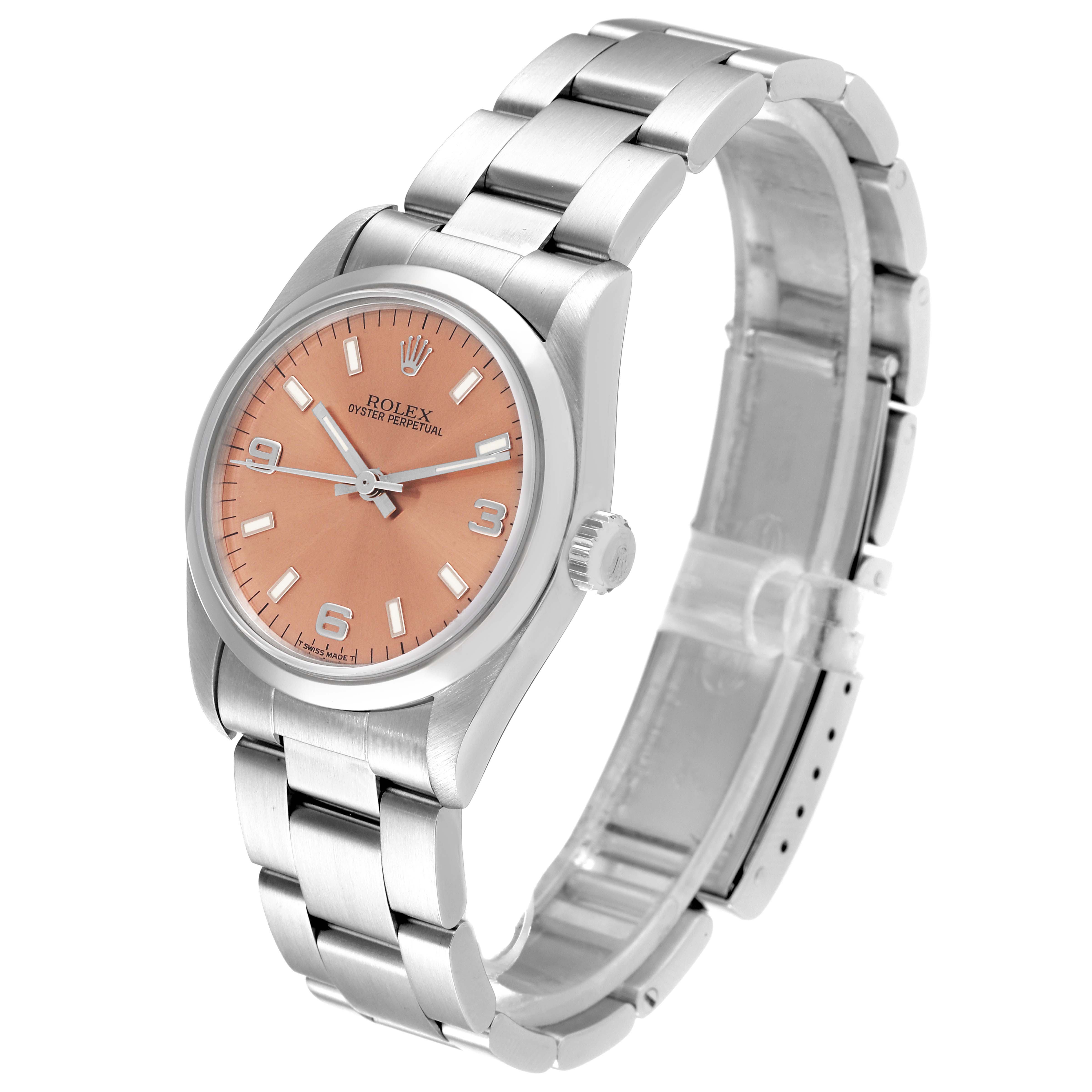 The image shows a side view of a mid-size Rolex Oyster Perpetual watch with a salmon-colored dial and a stainless steel bracelet.